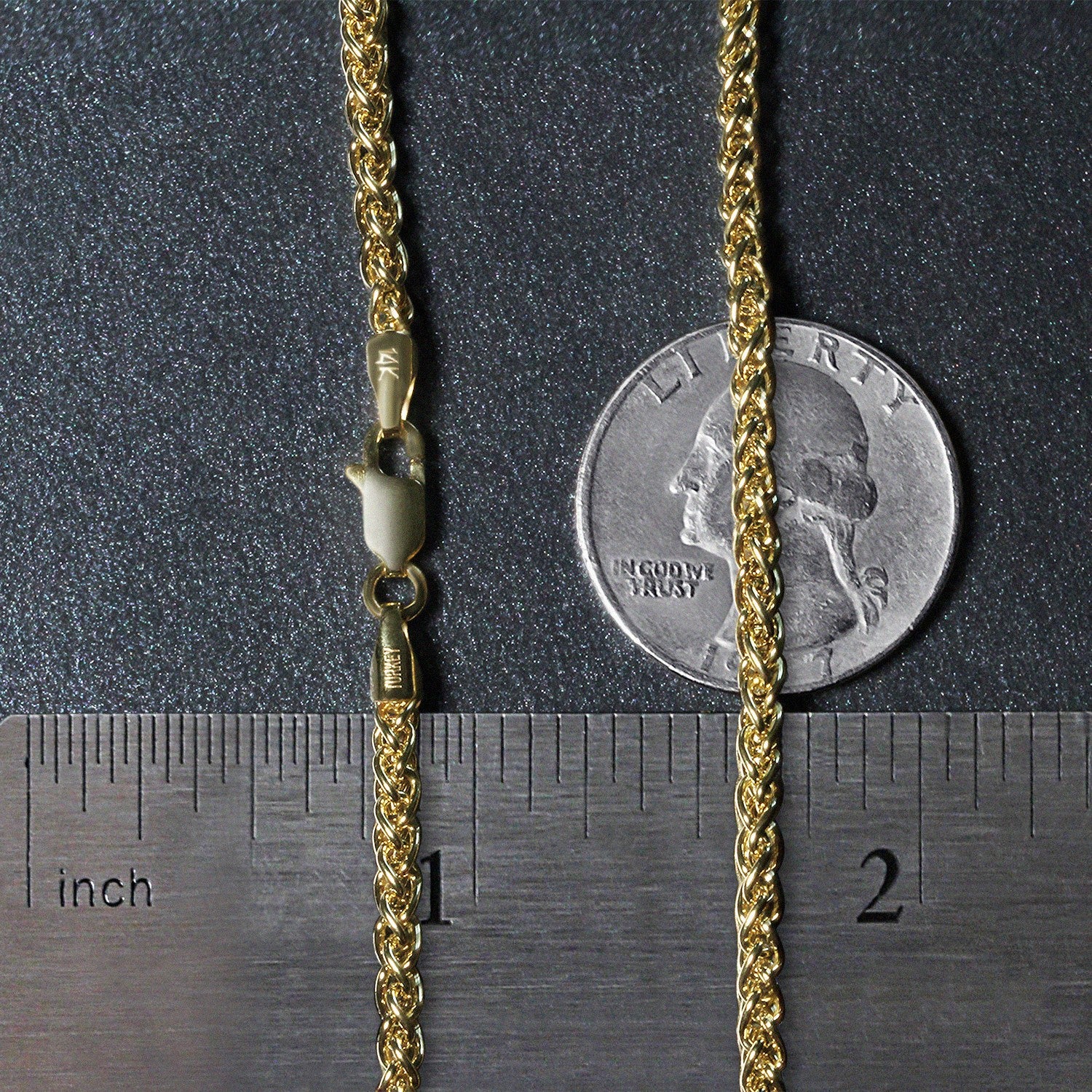 A 14k yellow gold light wheat chain with a lobster clasp, shown with a ruler and coin.