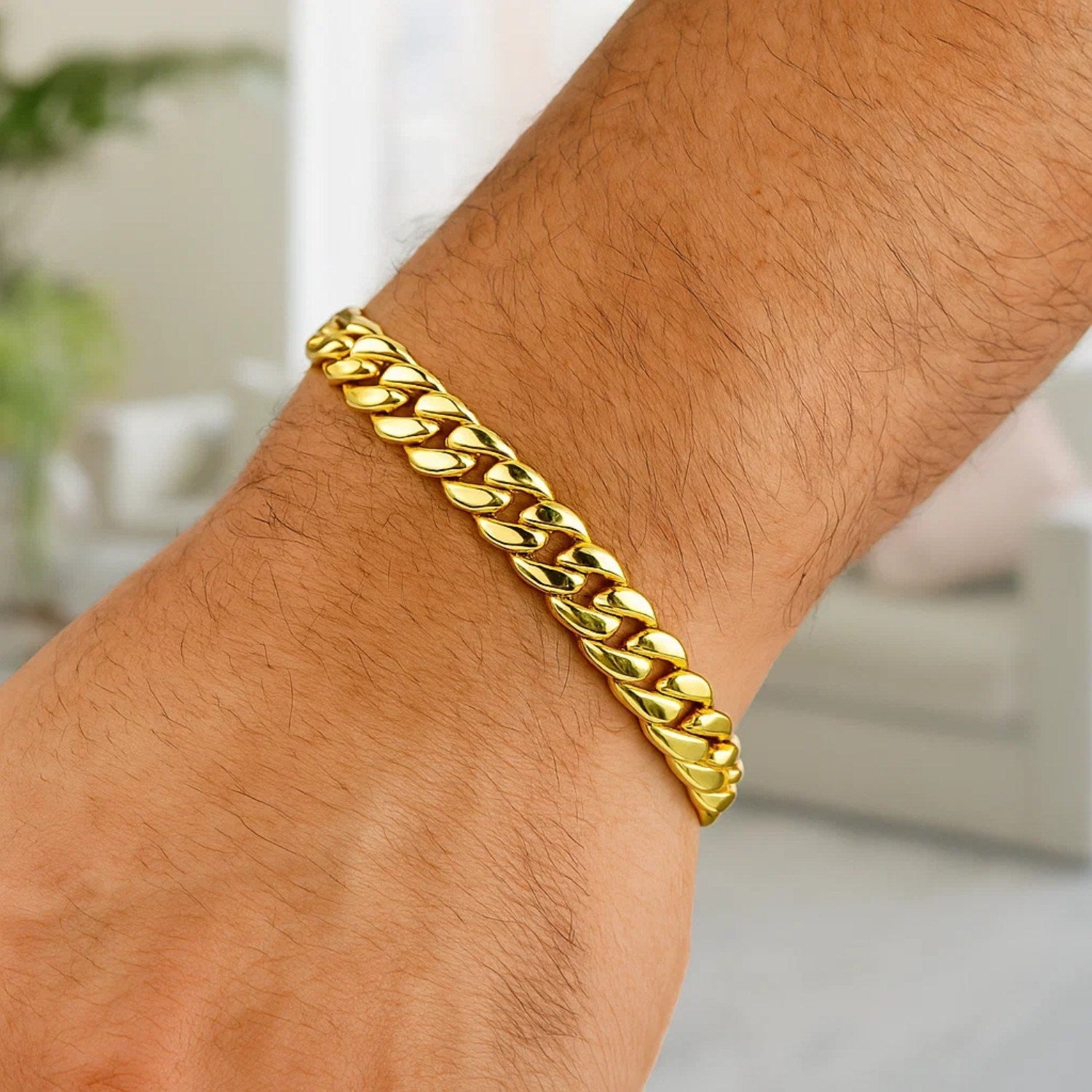 10k yellow gold semi-solid Miami Cuban bracelet on a person's arm.