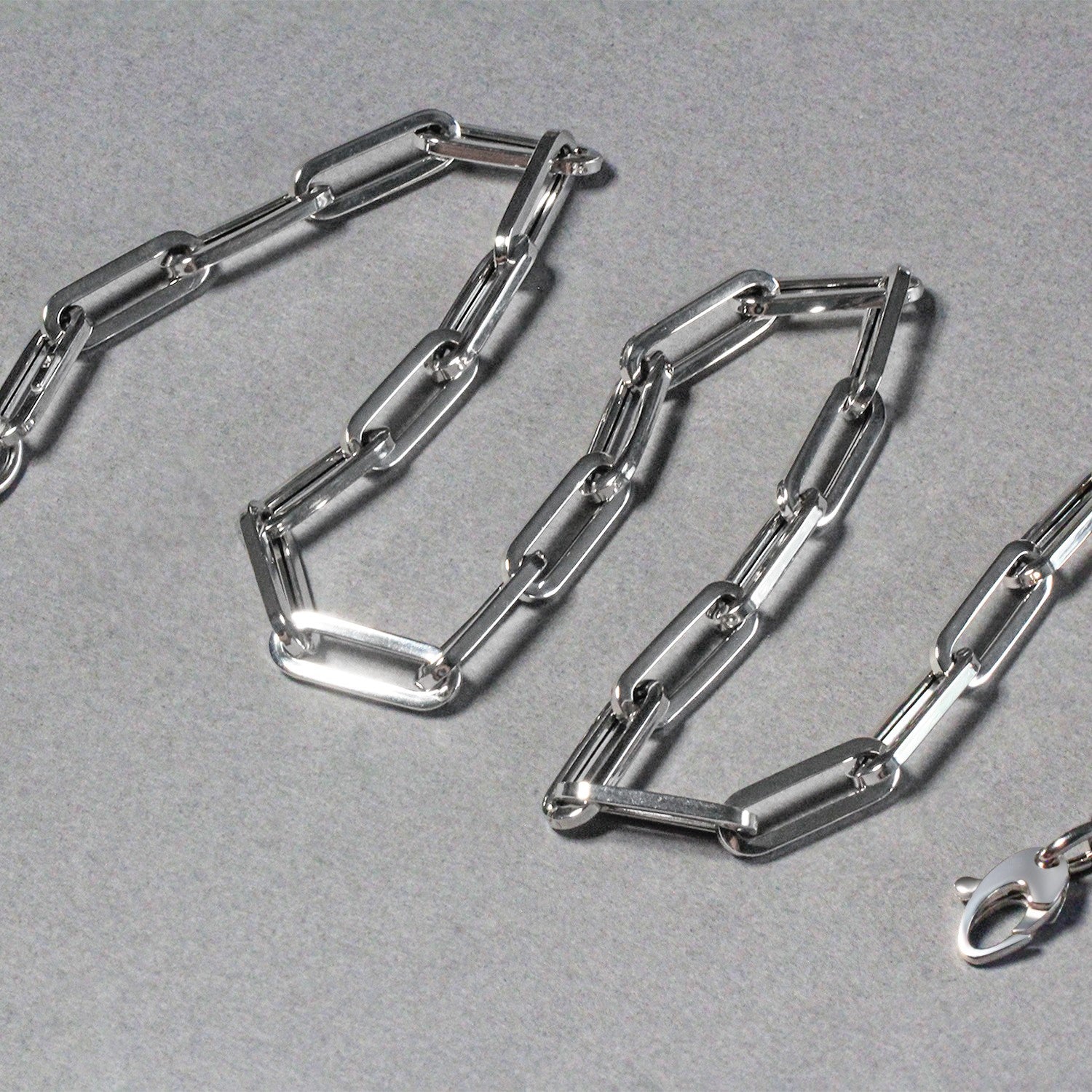 14K white gold wide paperclip chain with a lobster clasp.