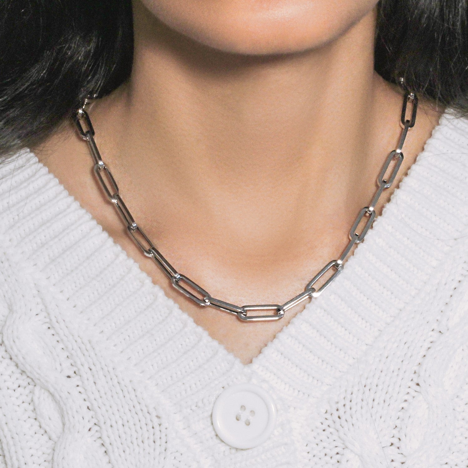 14K white gold wide paperclip chain with 6.10 mm links on a person wearing a white sweater.