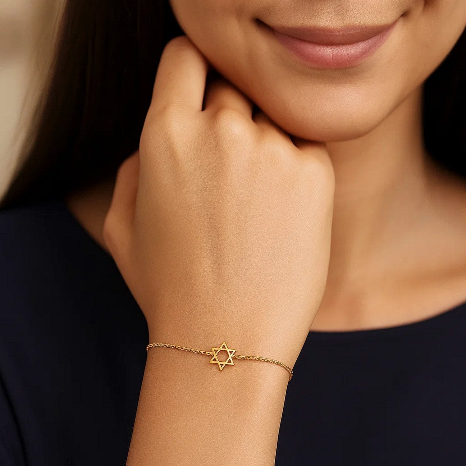 14k yellow gold Star of David bracelet on a woman's wrist.