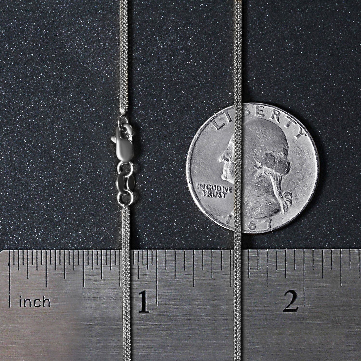 14k white gold foxtail chain with a lobster clasp, shown with a ruler and coin.