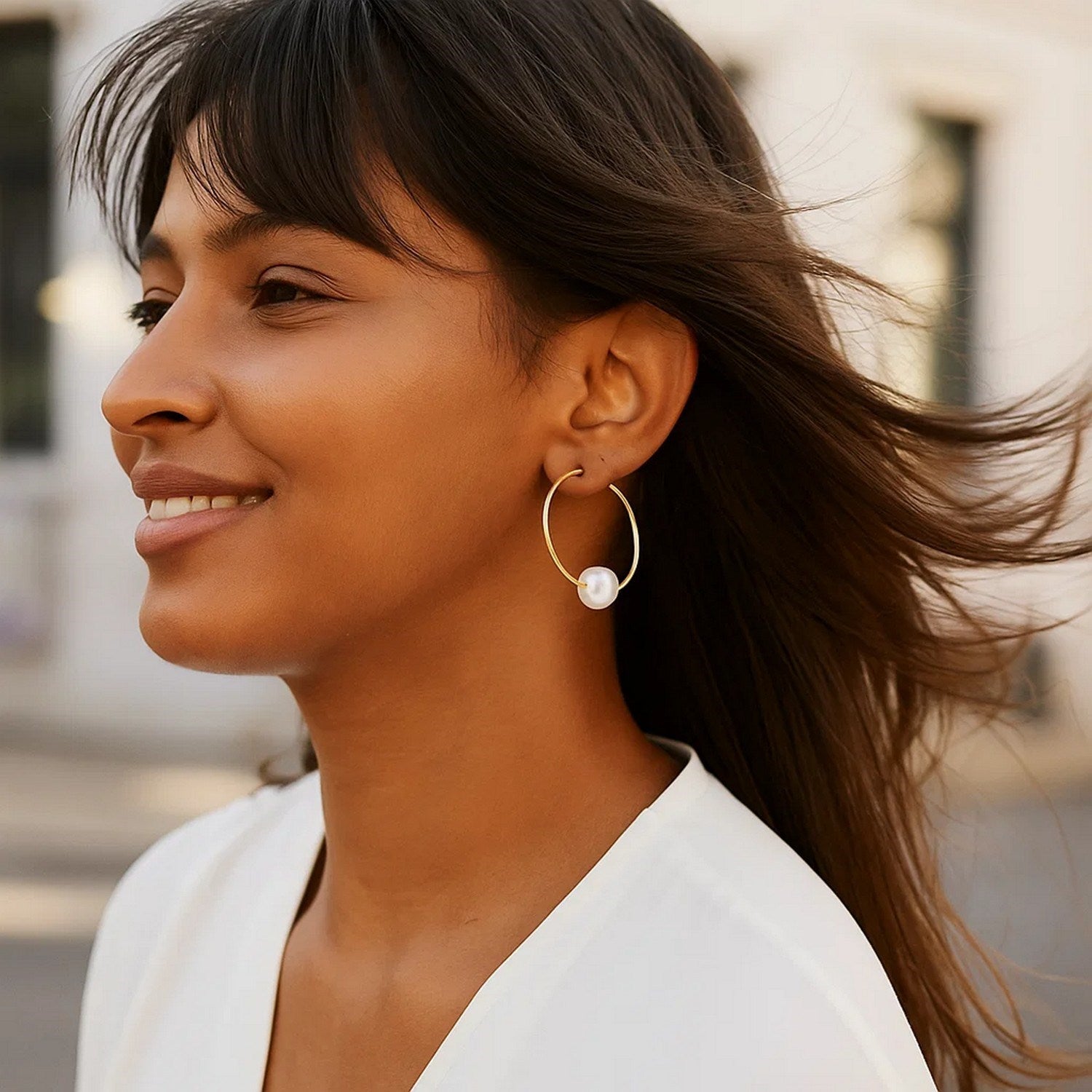 14k yellow gold endless hoop earring with a single round pearl.