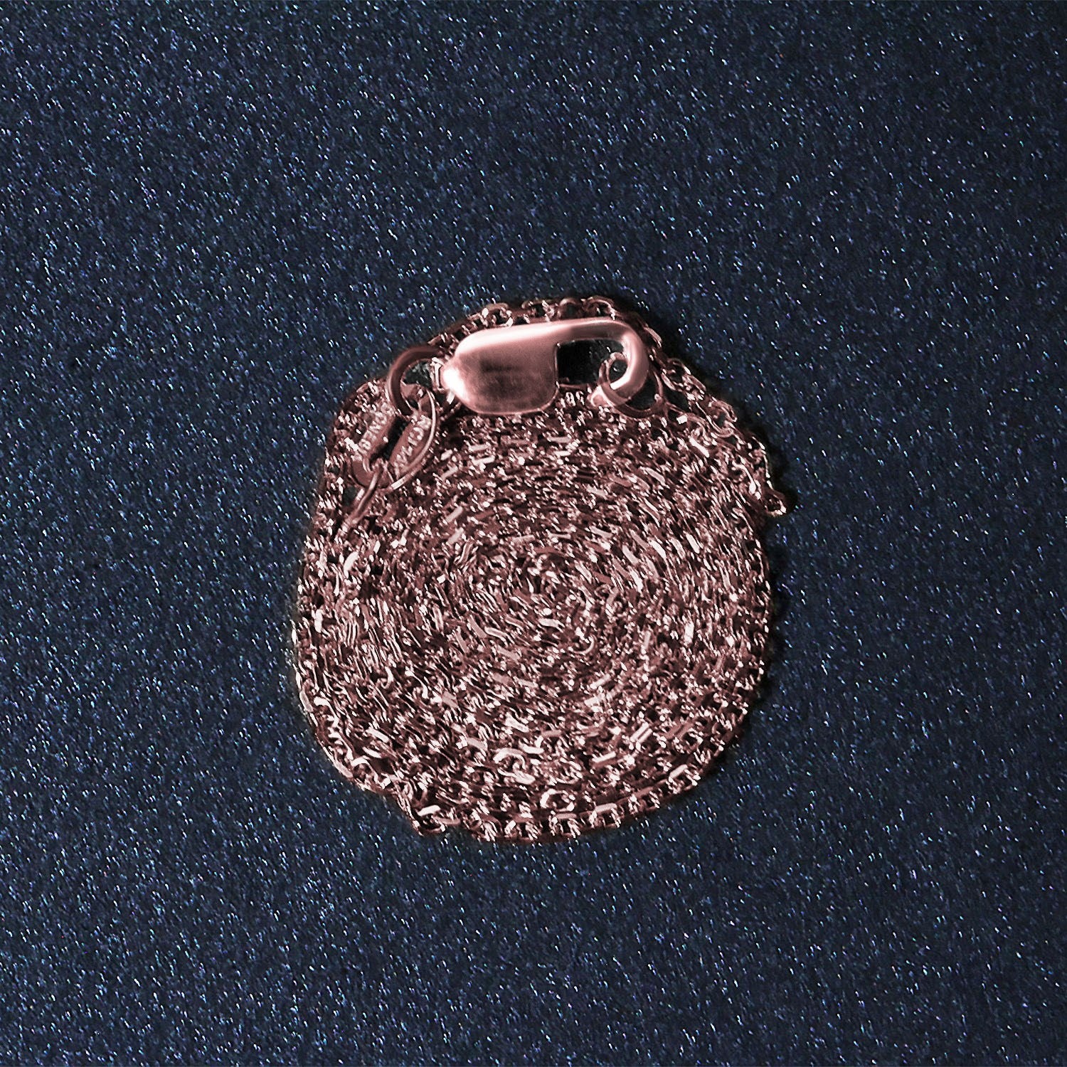 A coiled 14k rose gold diamond-cut cable link chain with a lobster clasp.