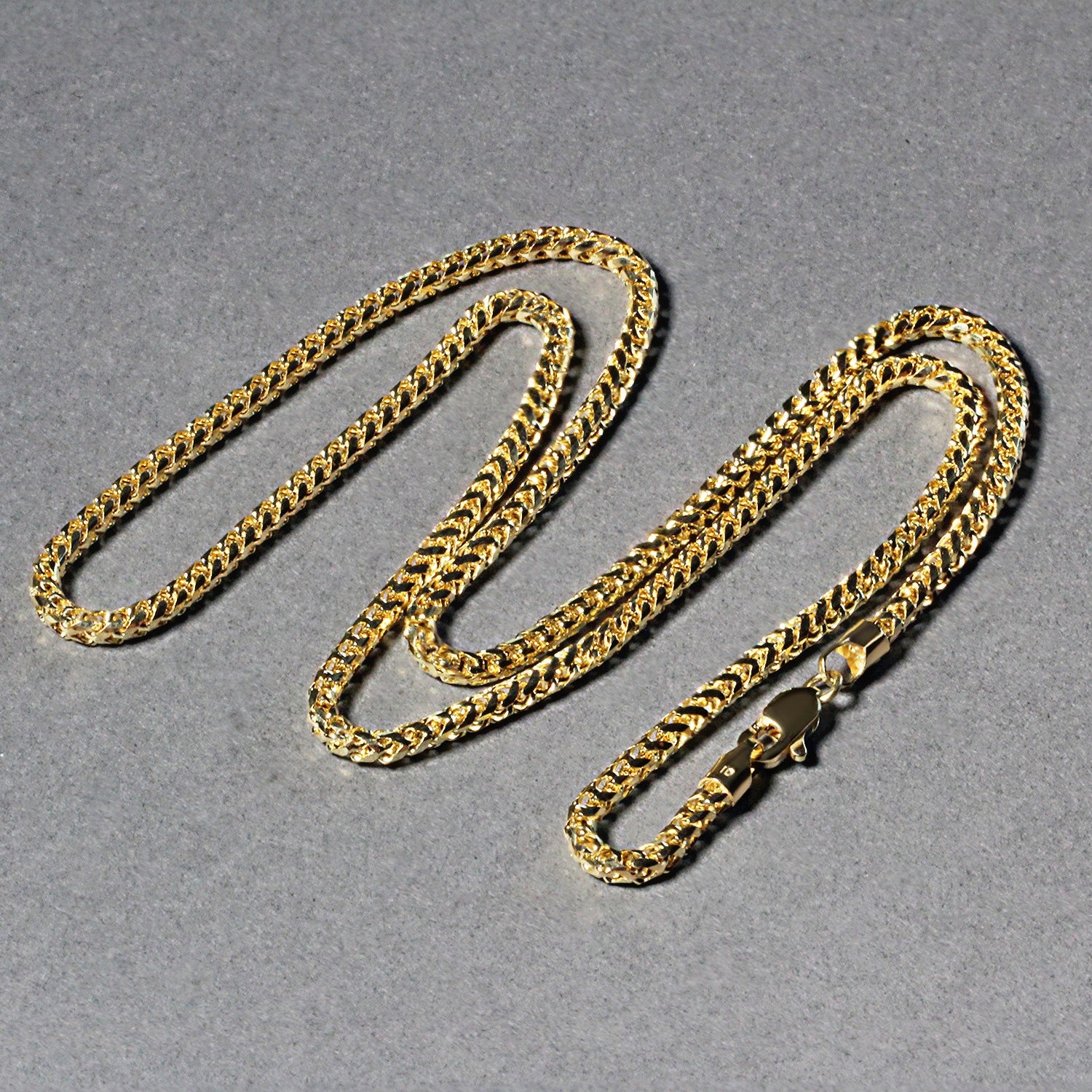 A 14k yellow gold diamond-cut round Franco chain with a lobster clasp.