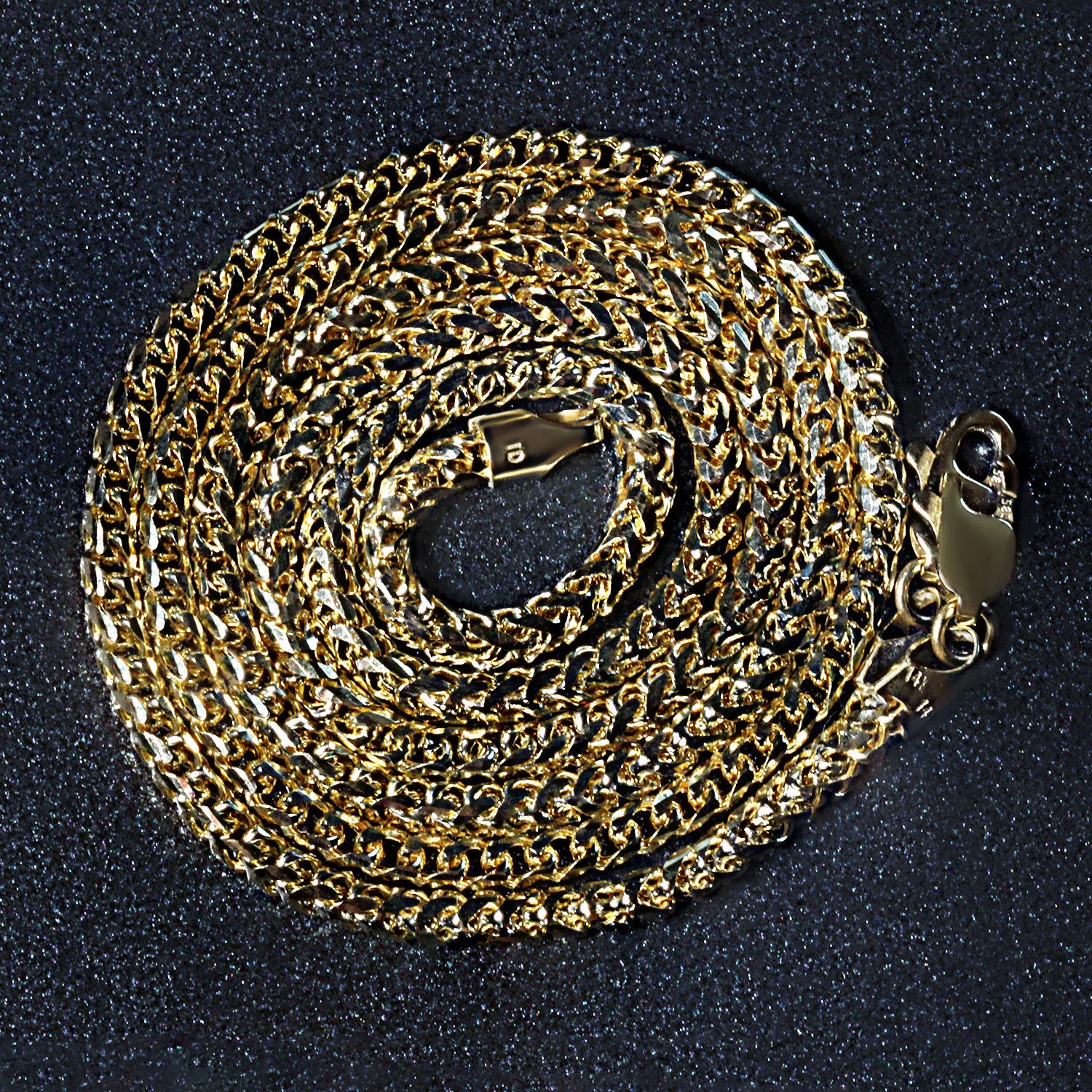 A 14k yellow solid gold diamond cut round Franco chain with a lobster clasp.
