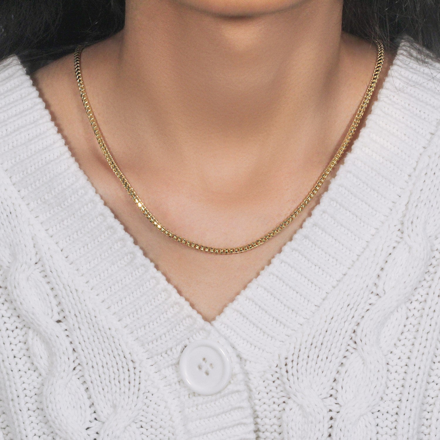 14k yellow gold diamond cut round franco chain on a person's neck.