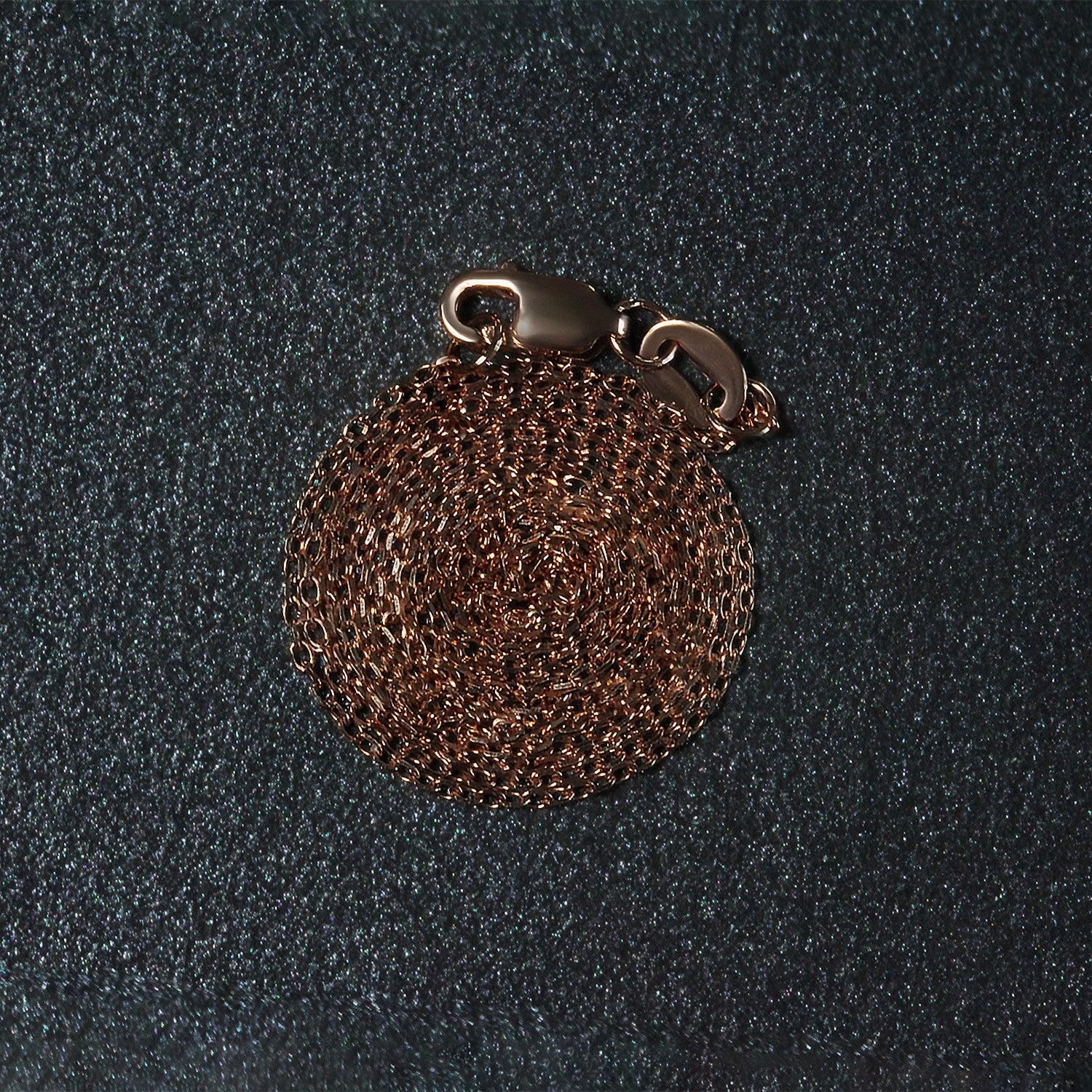 A coiled rose gold diamond cut cable link chain with a lobster clasp.