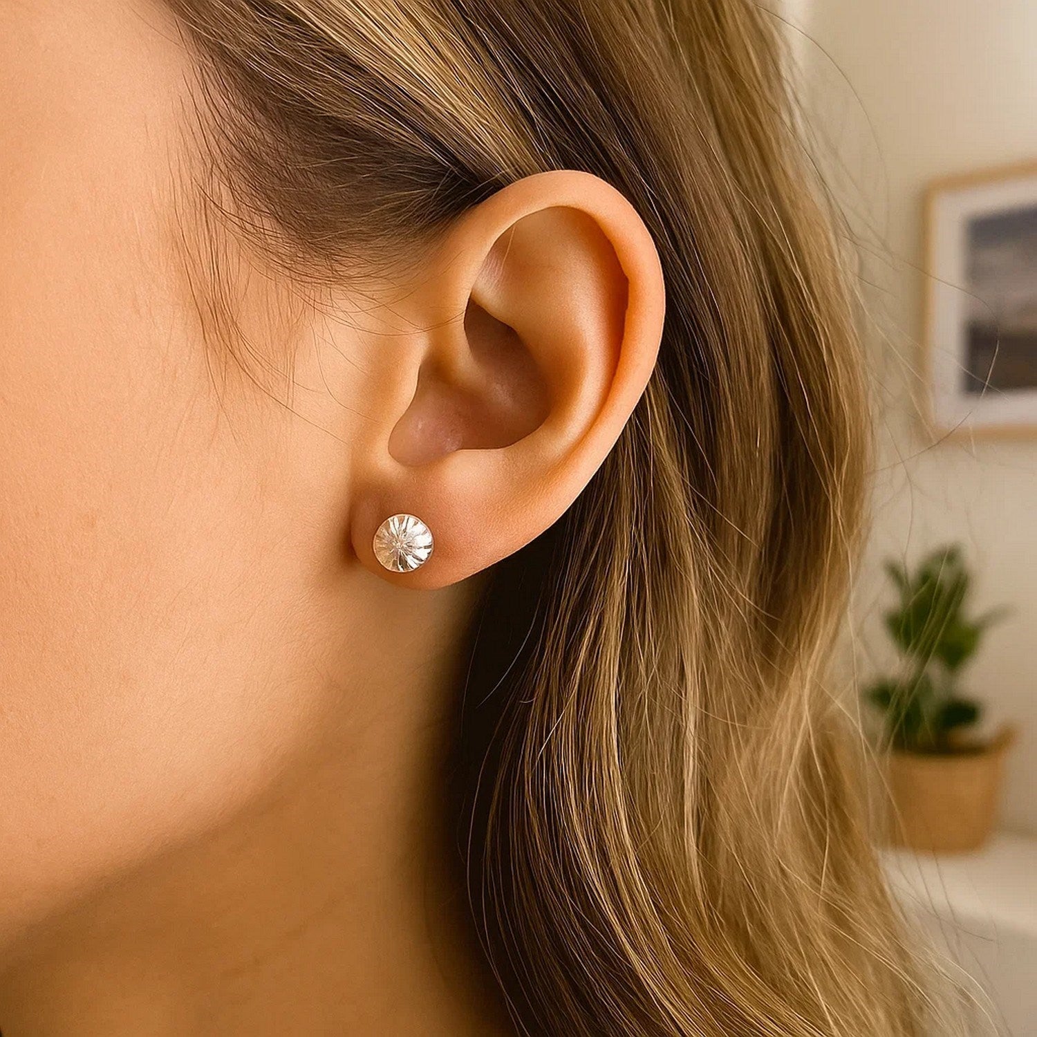 14k white gold textured flat style stud earrings with a sunburst design.