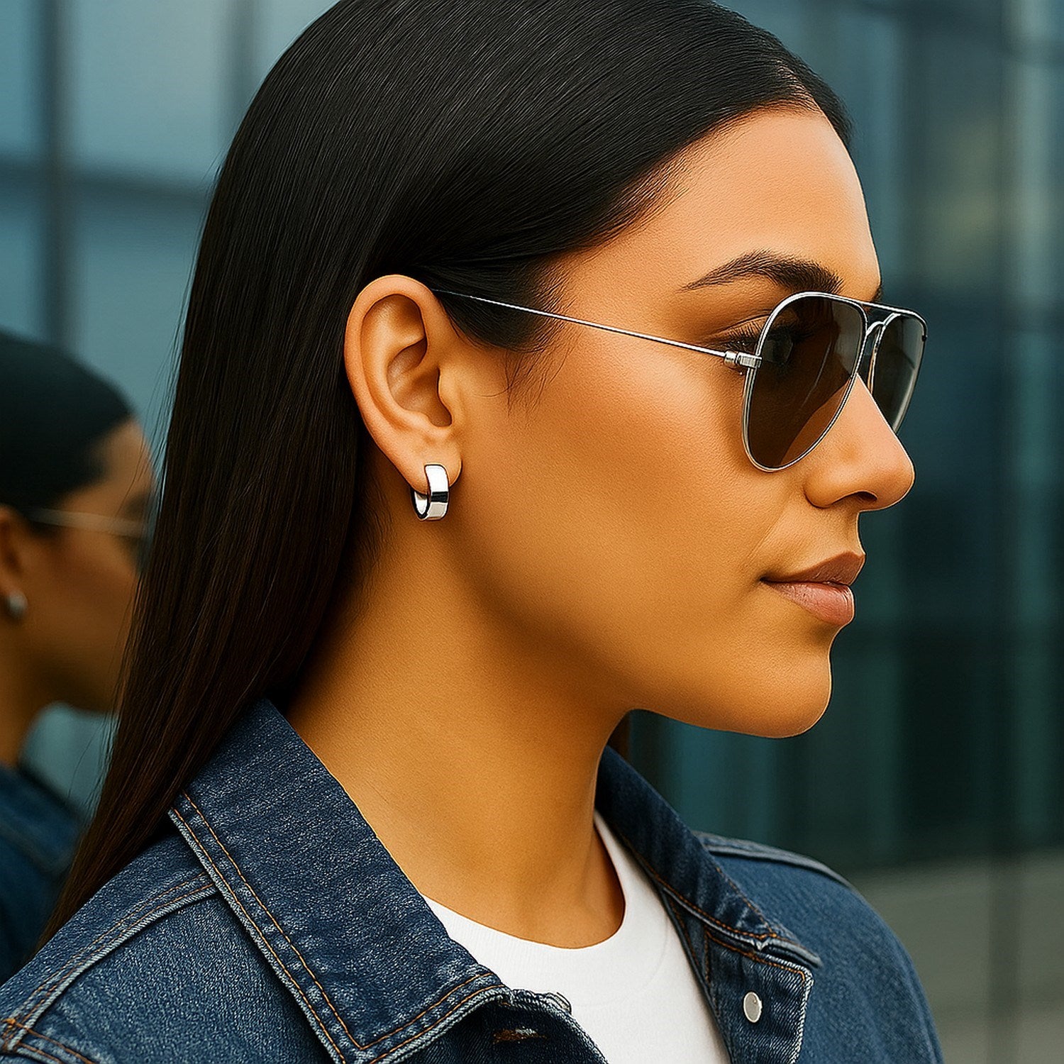 14k white gold snuggable hoop earrings on a woman's ear.