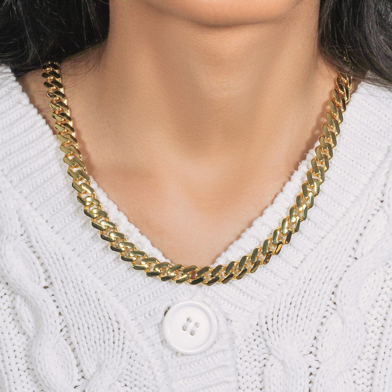 14k yellow gold 22-inch polished curb chain necklace on a person wearing a white sweater.