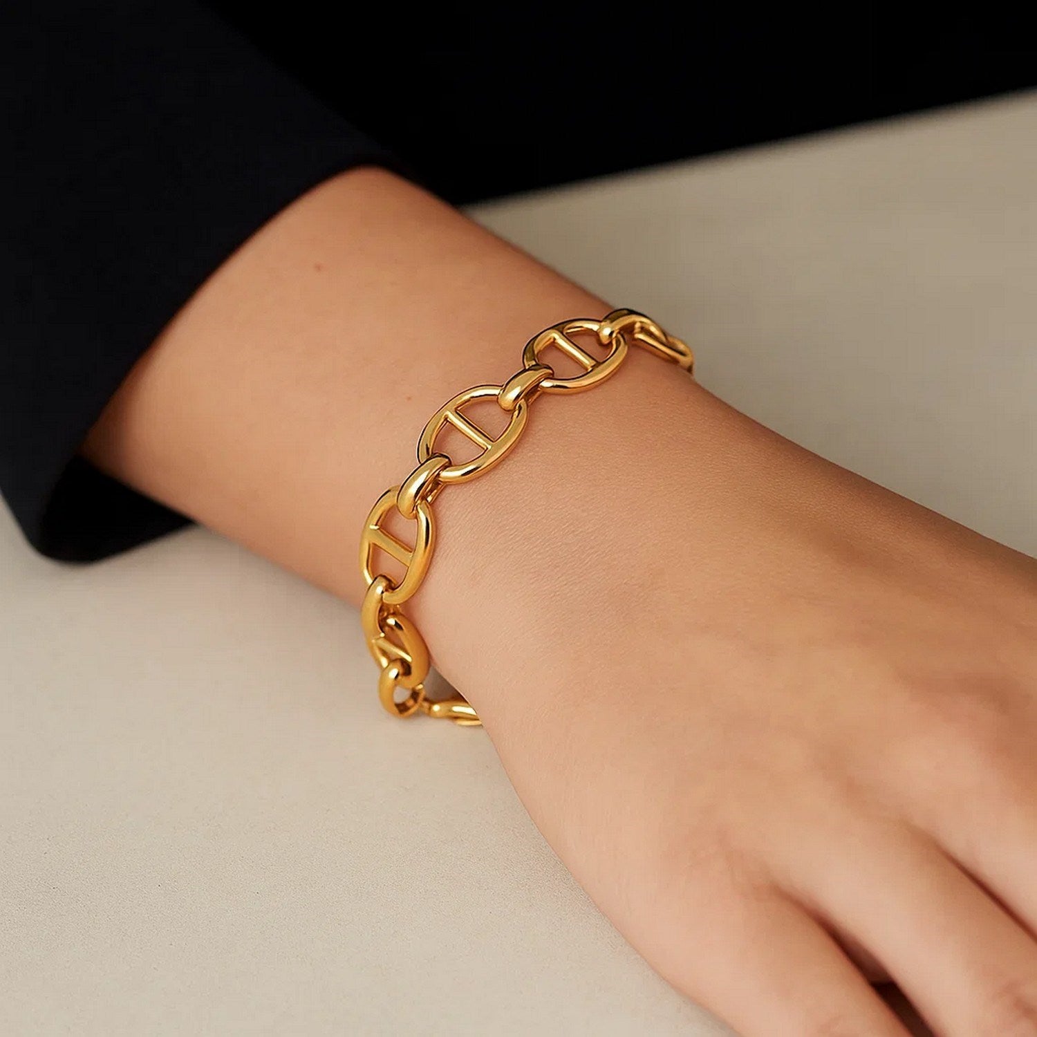 14k yellow gold high polish mariner link bracelet on a person's wrist.