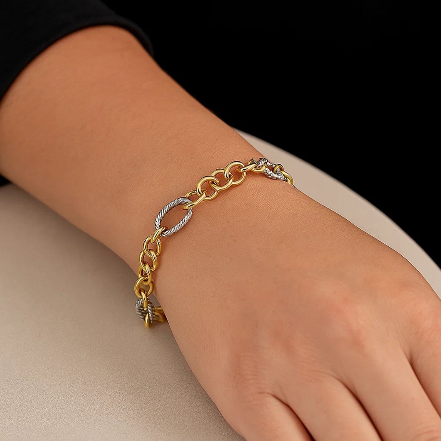 14k two-tone gold bracelet with alternating rope motif oval and round links.