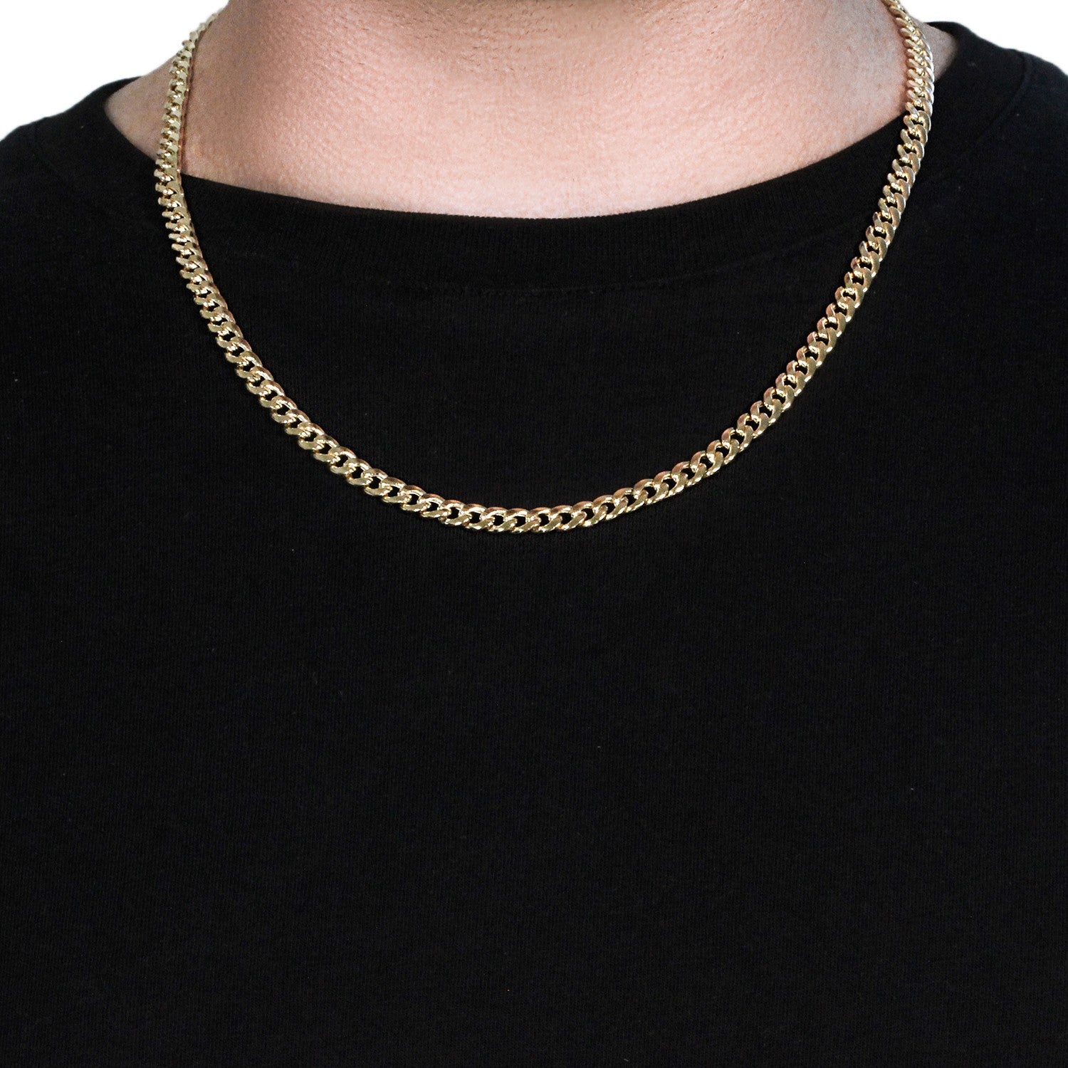 14k yellow gold Miami Cuban semi-solid chain on a person wearing a black shirt.