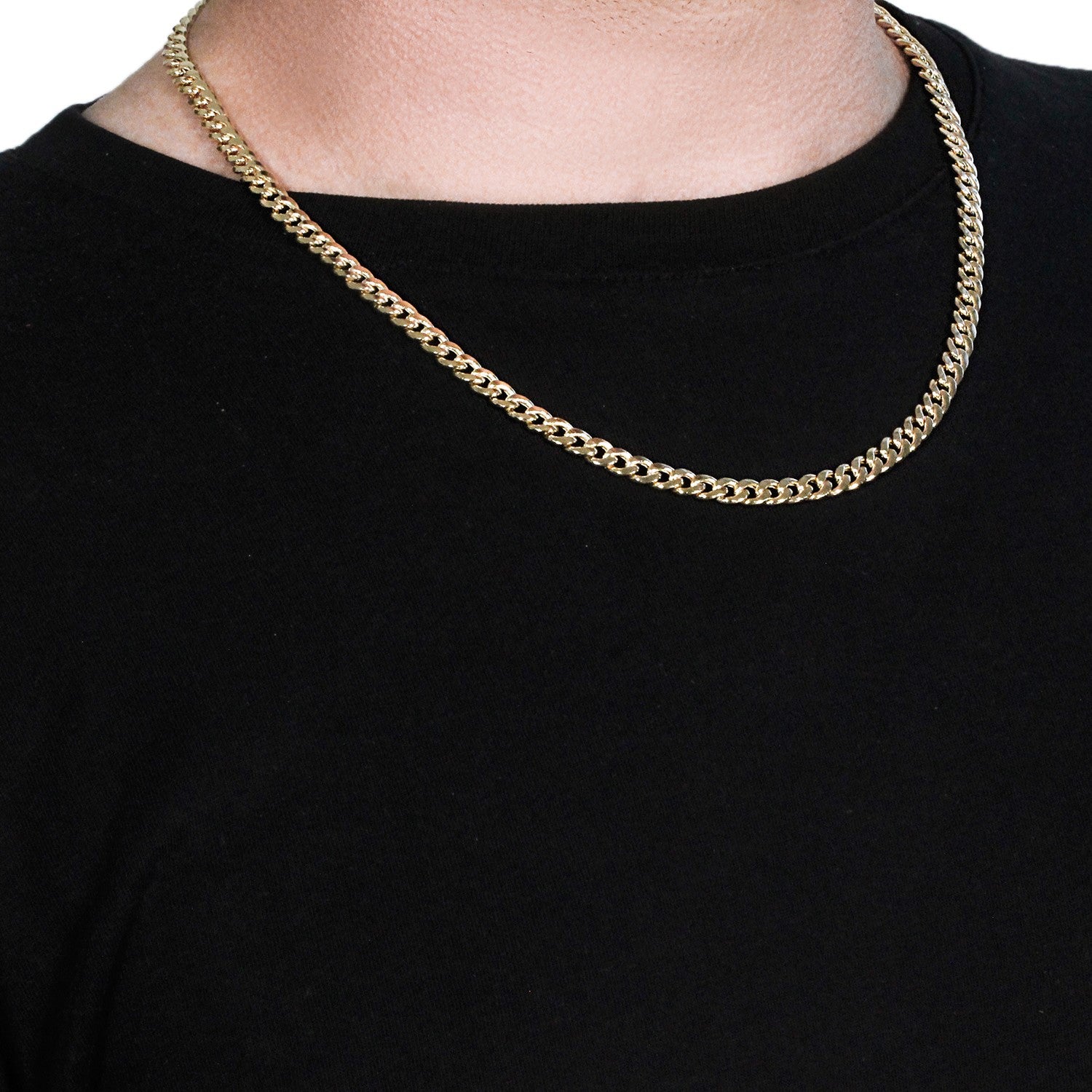 A 14k yellow gold Miami Cuban semi-solid chain with a lobster clasp on a person.