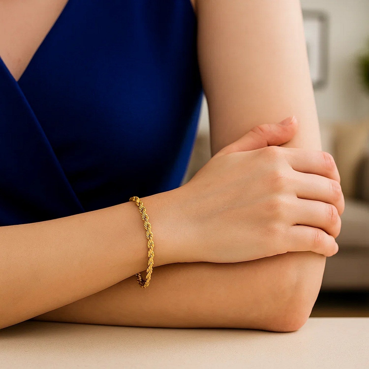 A woman wears a 10k yellow gold solid diamond cut rope bracelet.