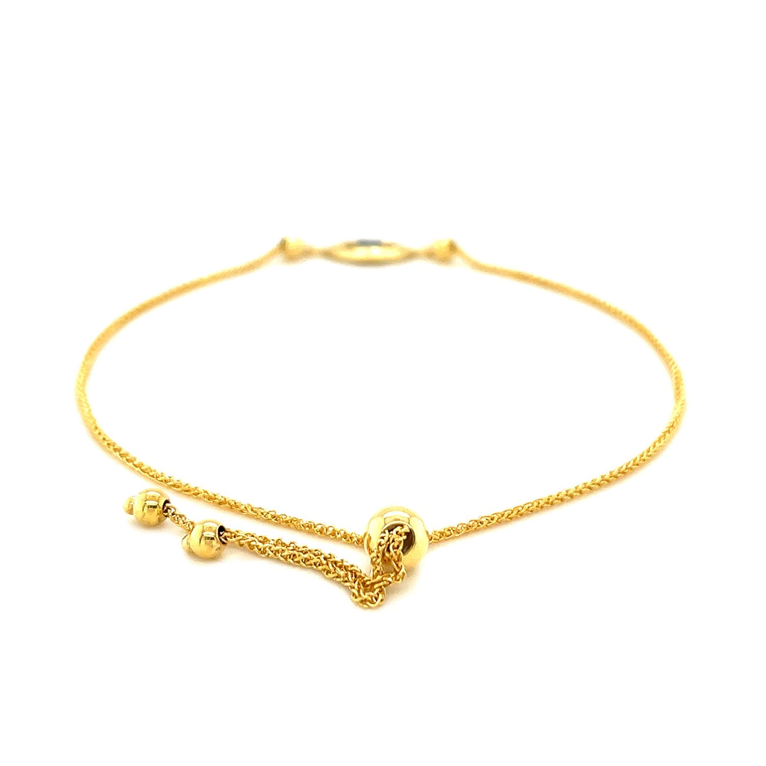 14k yellow gold adjustable evil eye bracelet with a drawstring clasp.