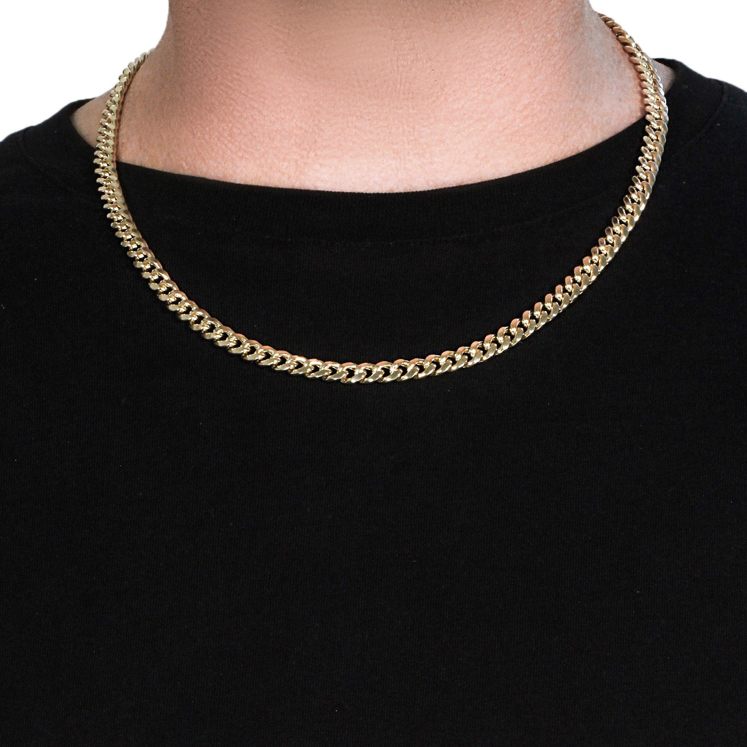 A 14k yellow gold semi-solid Miami Cuban chain, 6.60 mm wide, on a person.