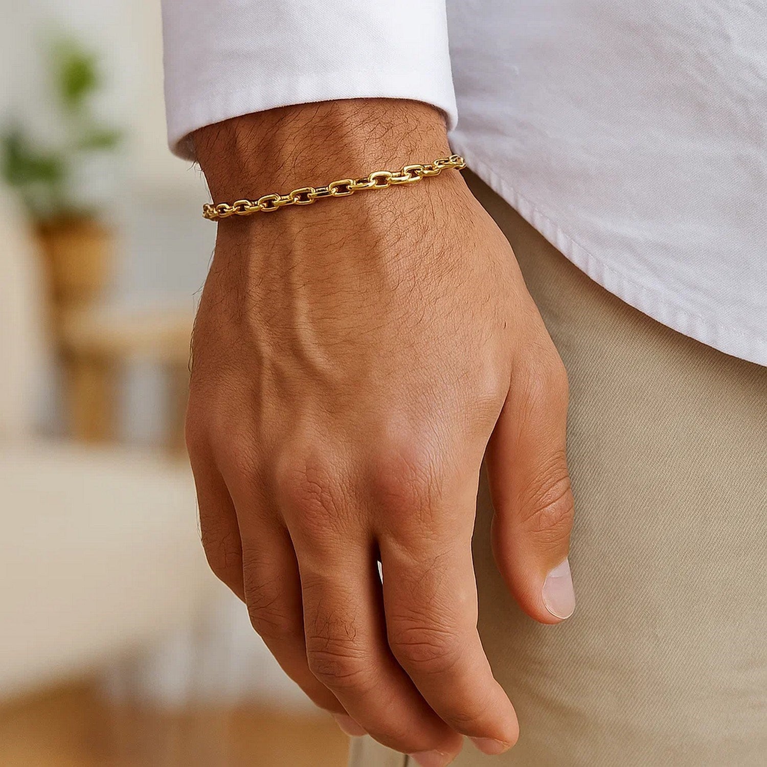 14k yellow gold French cable chain bracelet on a man's wrist.