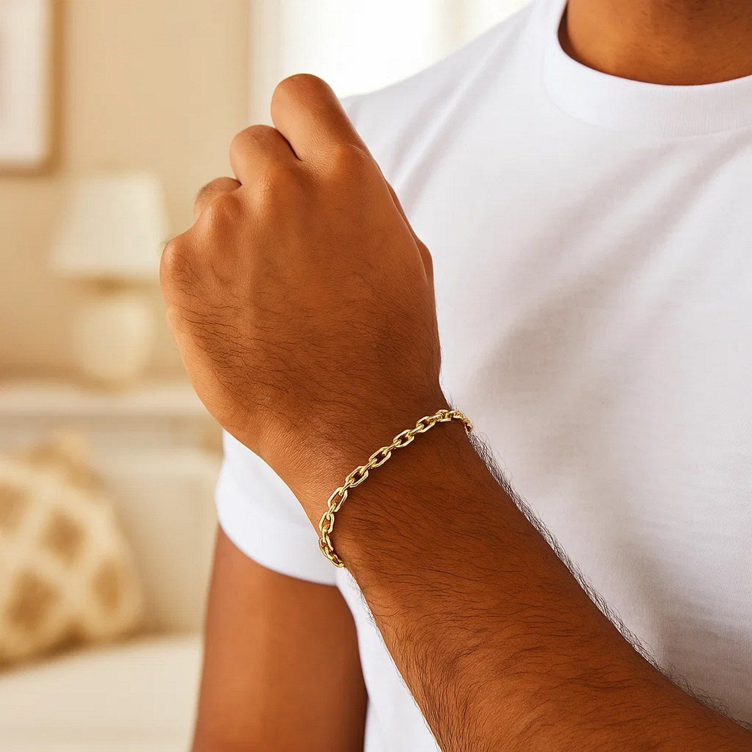 A 14k yellow gold French cable chain bracelet on a person's wrist.