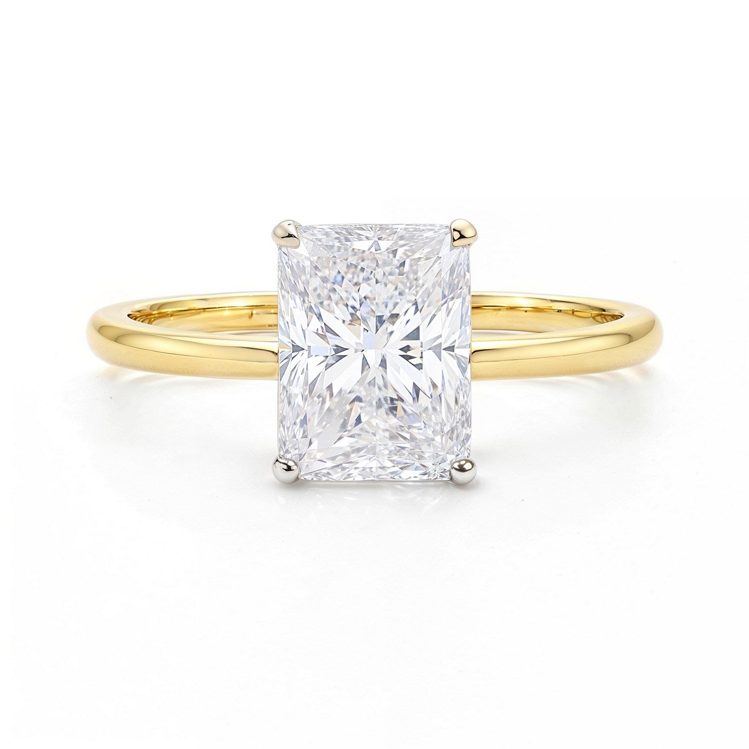 A radiant-cut lab-grown diamond solitaire ring with a yellow gold band.