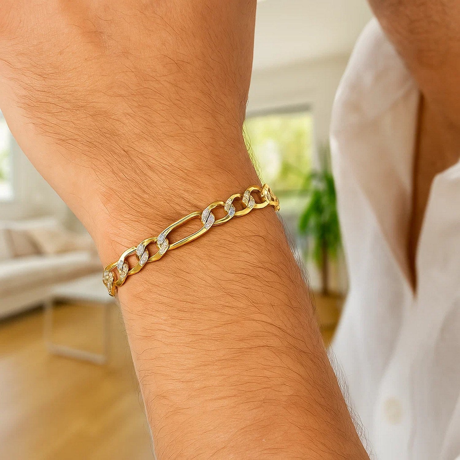 14K two-tone gold solid pave figaro bracelet on a person's wrist.