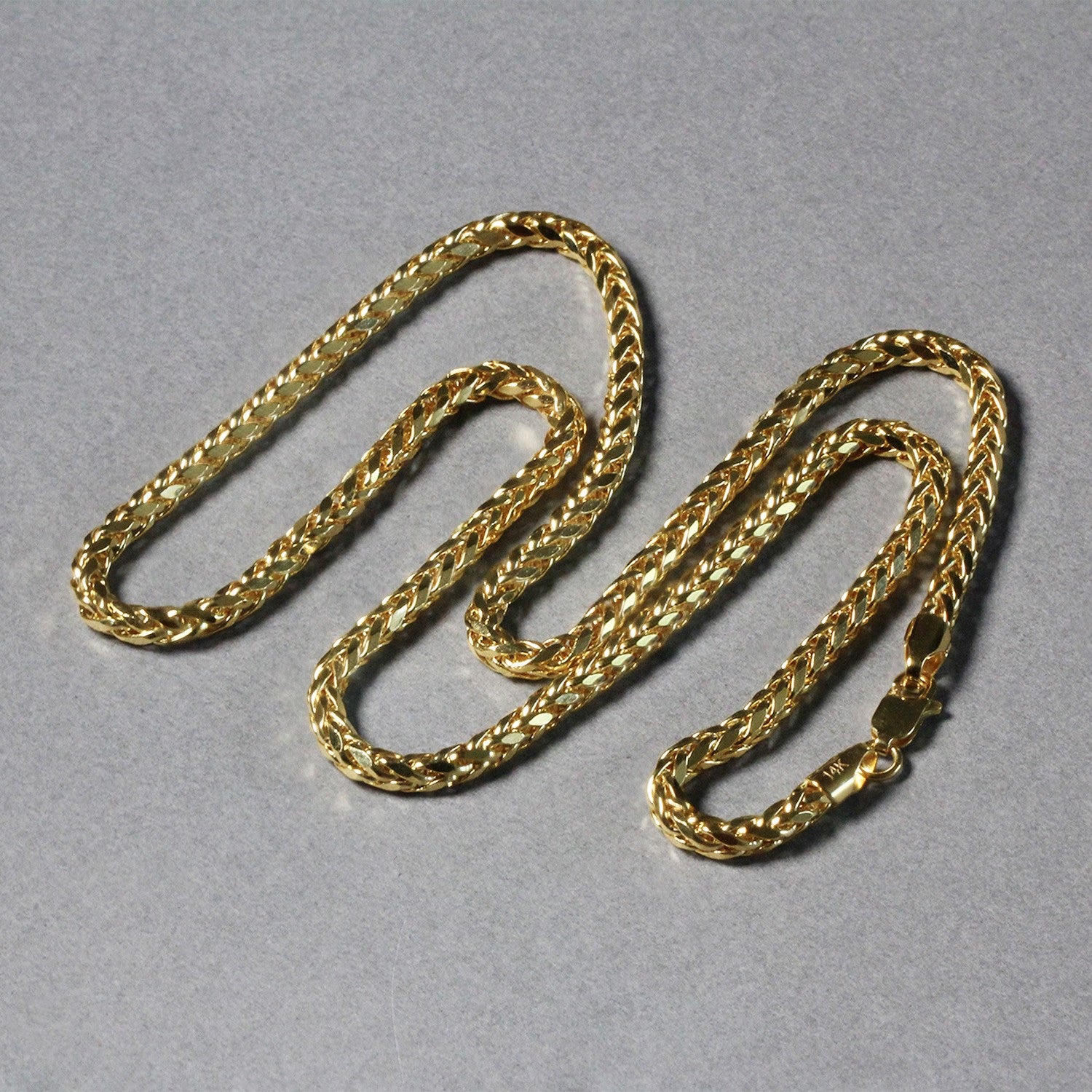 A 14k yellow gold diamond-cut round Franco chain with a lobster clasp.