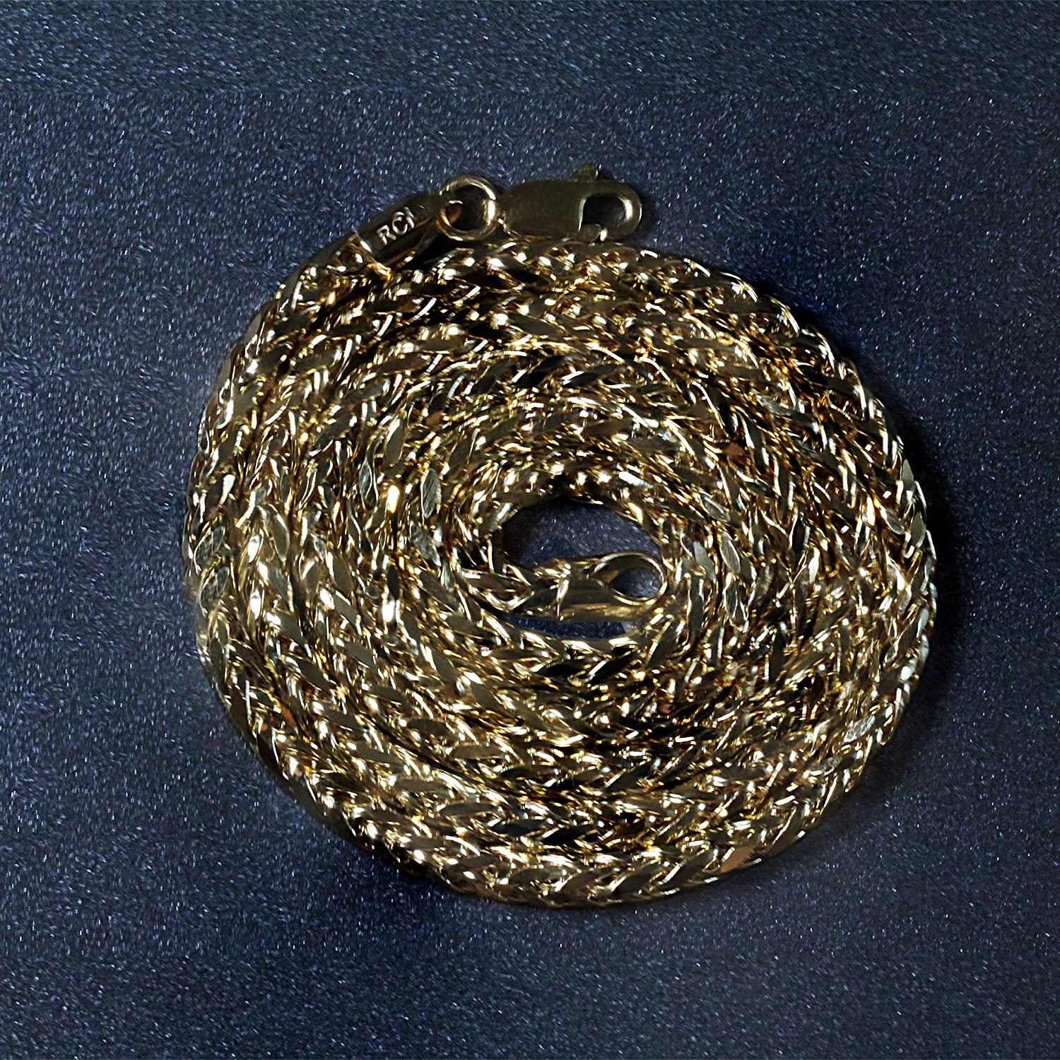 14k yellow gold diamond cut round franco chain with a lobster clasp.