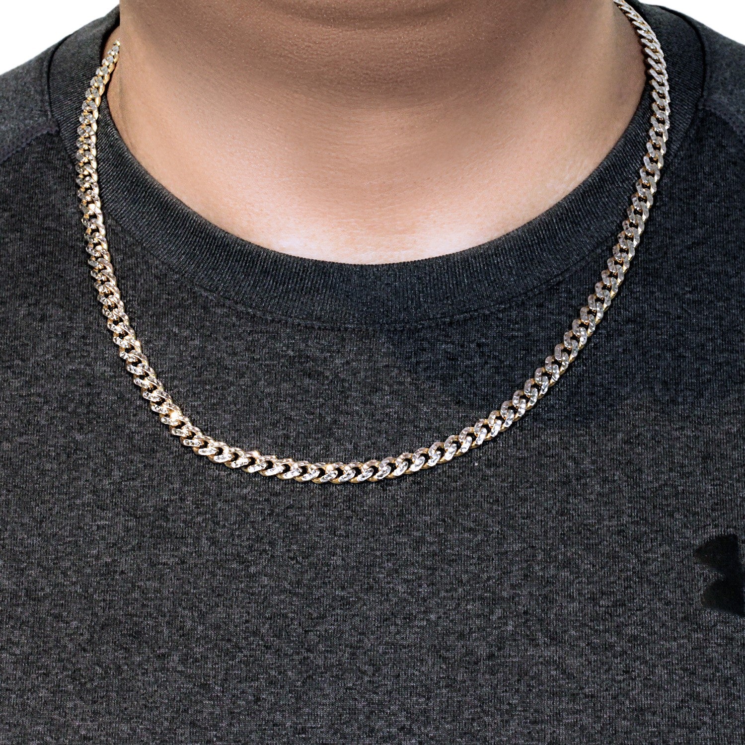 A 14k yellow gold Miami Cuban chain with white pave on a person's neck.