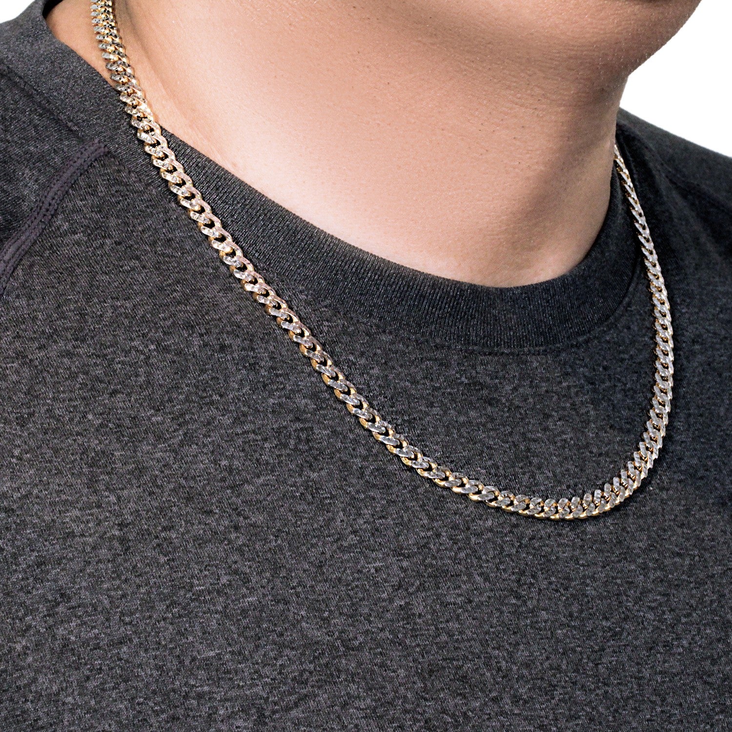 14k yellow gold and white pave Miami Cuban chain on a person's neck.