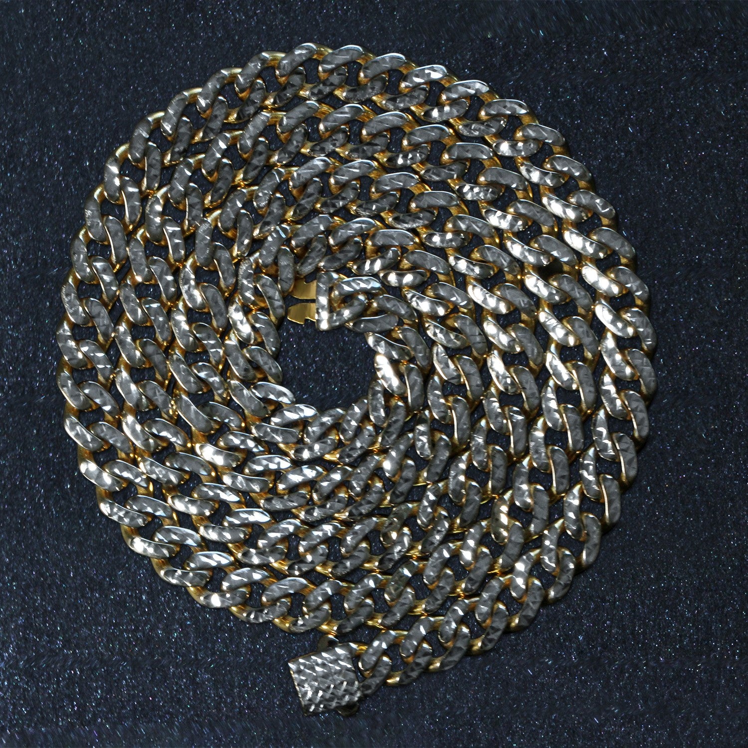 A 14k yellow gold and white pave Miami Cuban chain with a high polish finish.