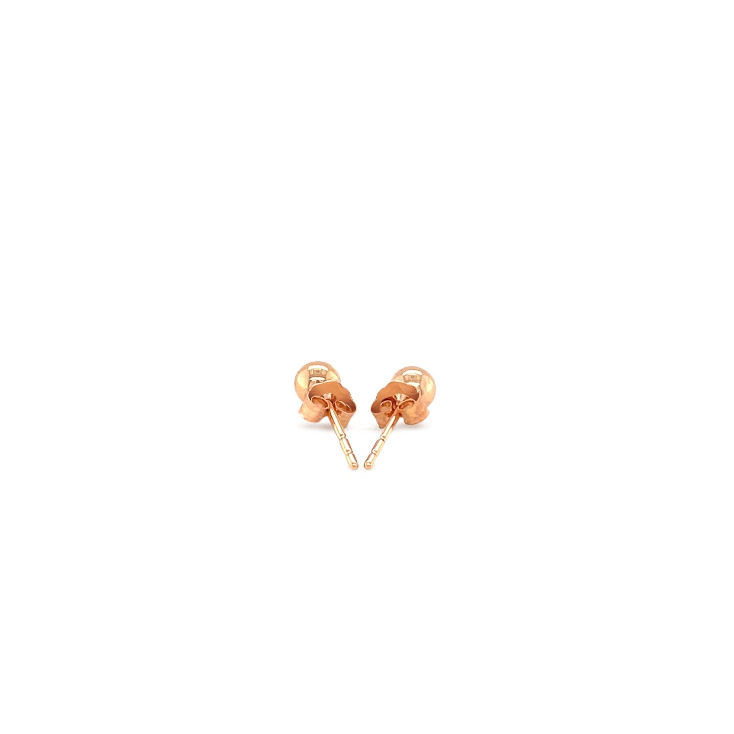 A pair of 14k rose gold ball style stud earrings with push backs.