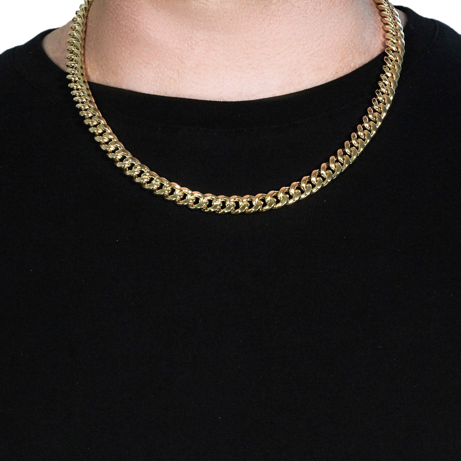 A 14k yellow gold semi-solid Miami Cuban chain, 9.10 mm wide, on a person.