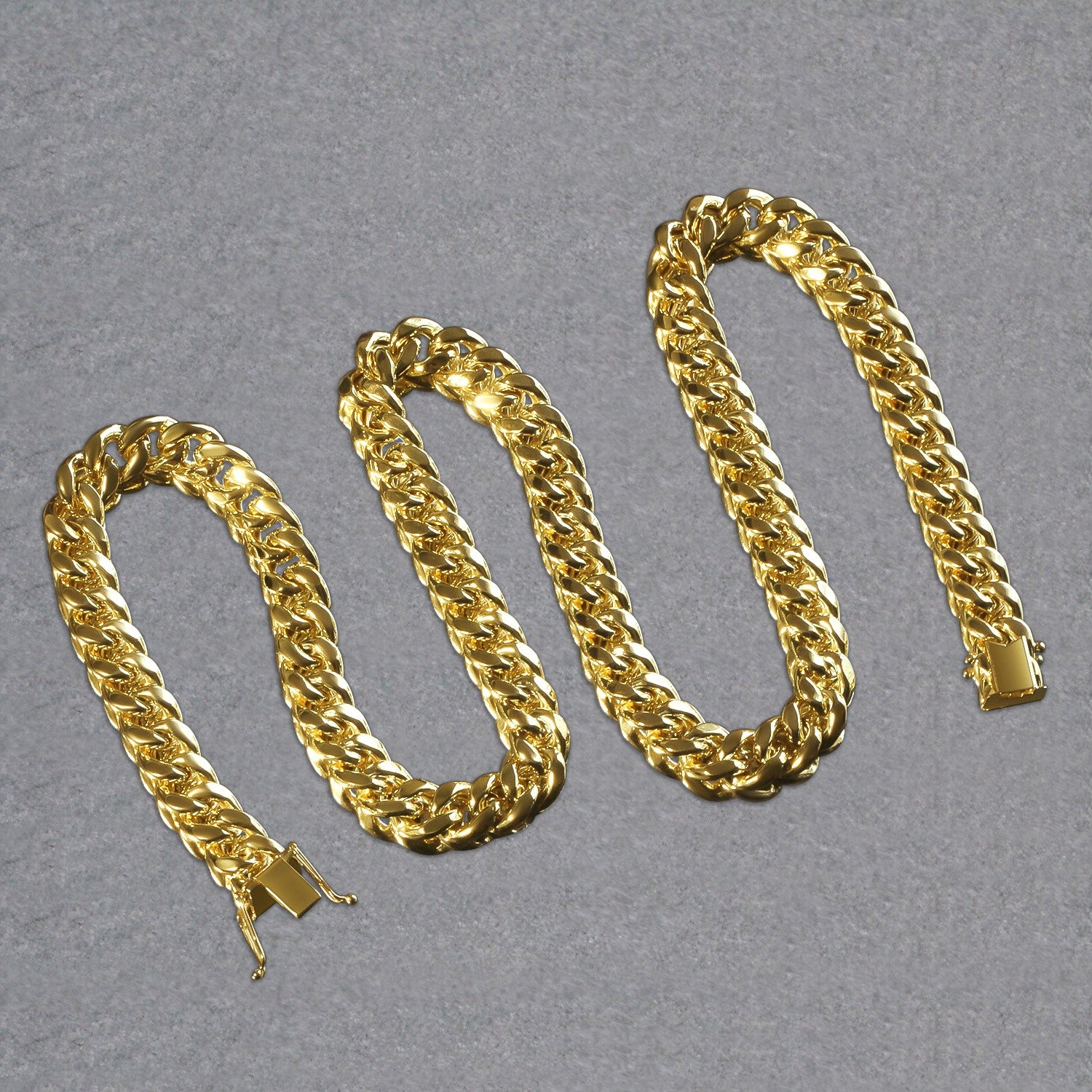 A shiny 14k yellow gold semi-solid Miami Cuban chain with a box clasp.