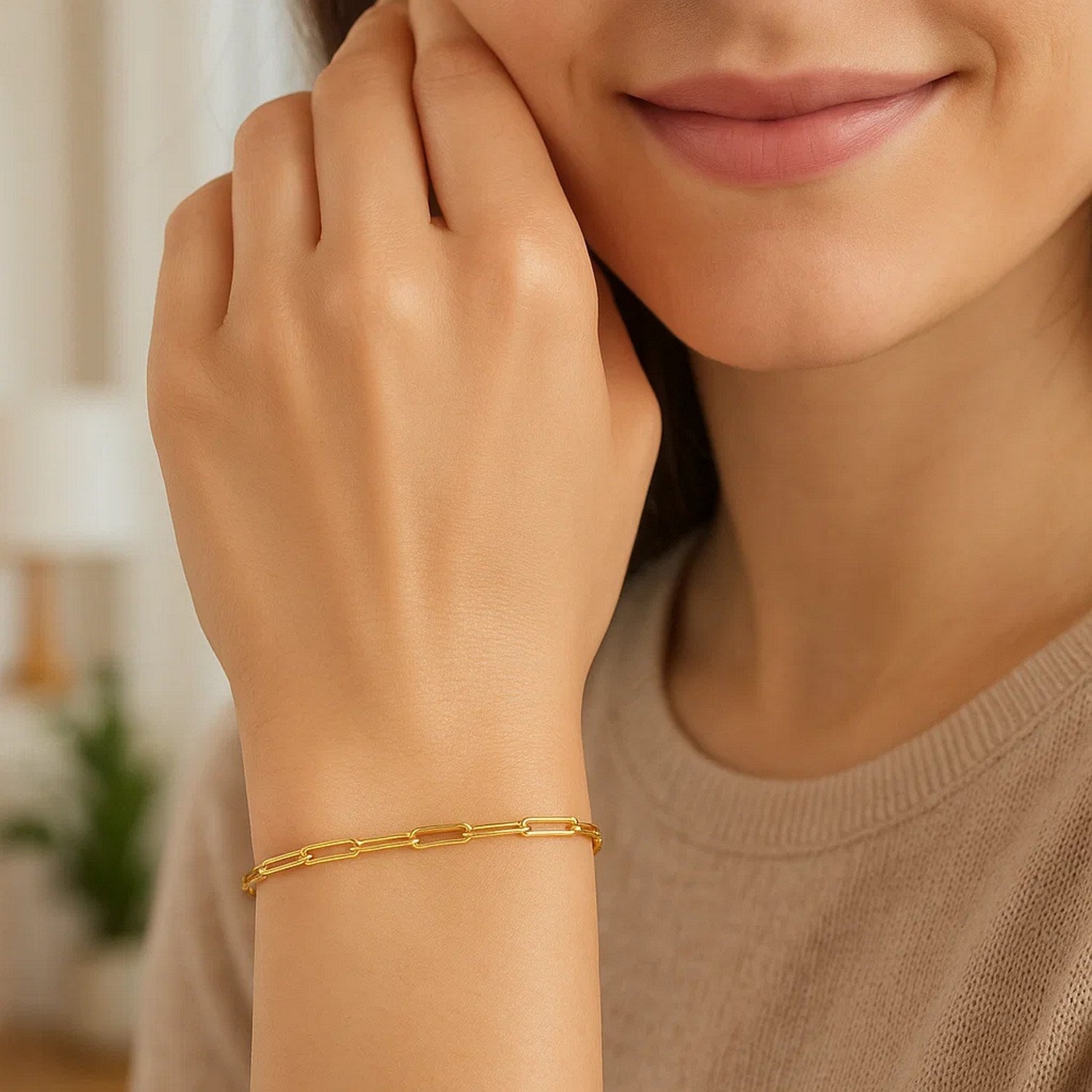 14K yellow gold paperclip bracelet with 2.50 mm links on a woman's wrist.