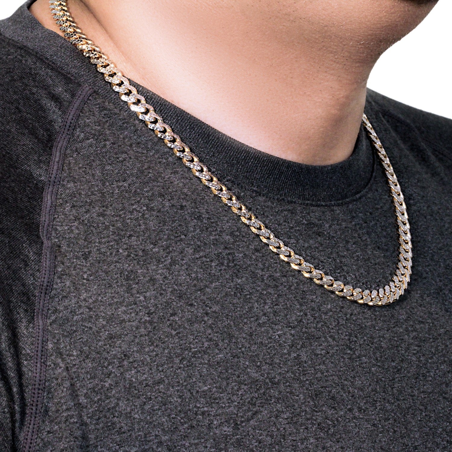 A 14k yellow gold and white pave Modern Lite Miami Cuban chain on a person's neck.
