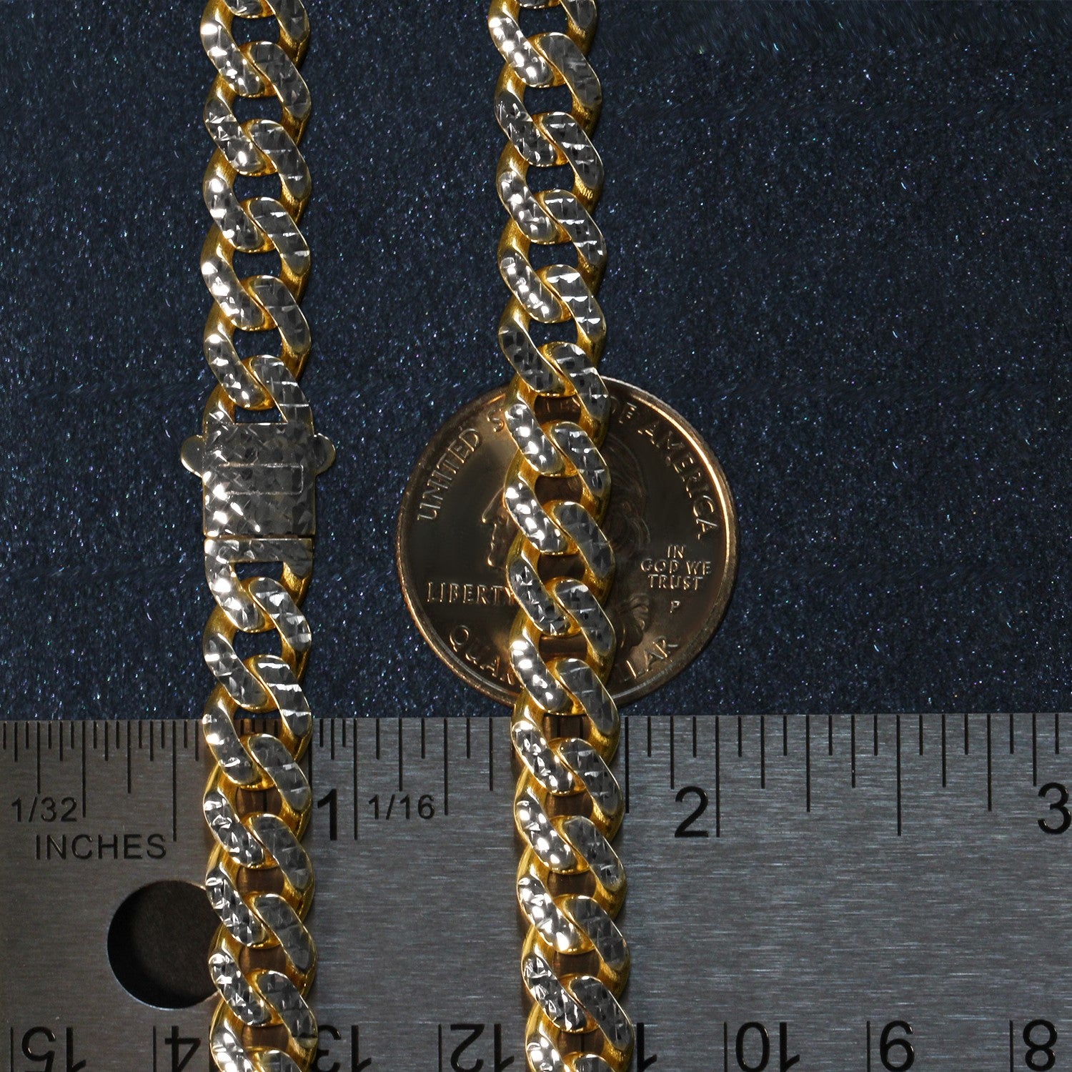A two-tone gold Miami Cuban chain with a box clasp, measured against a ruler and coin.