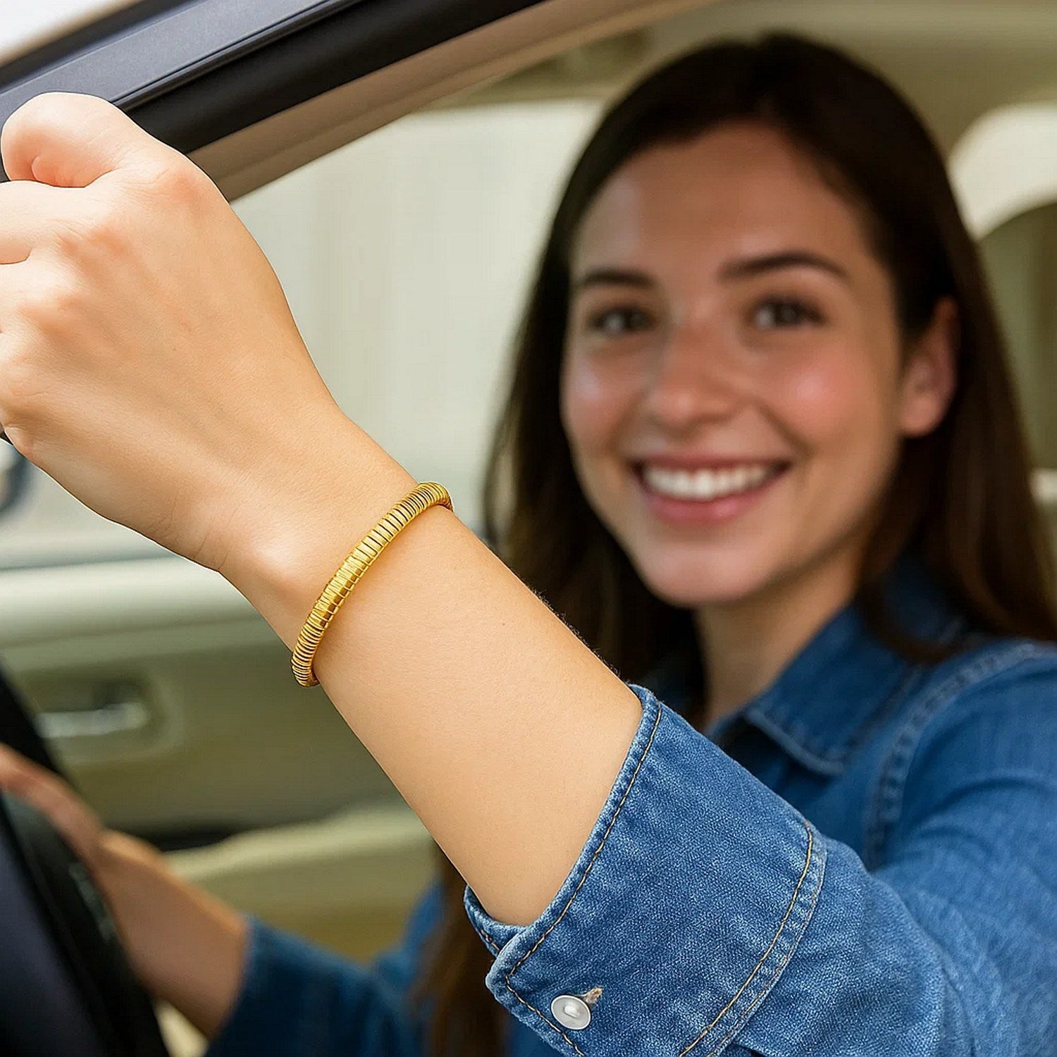 14K yellow gold Tubogas bracelet on a woman's wrist.