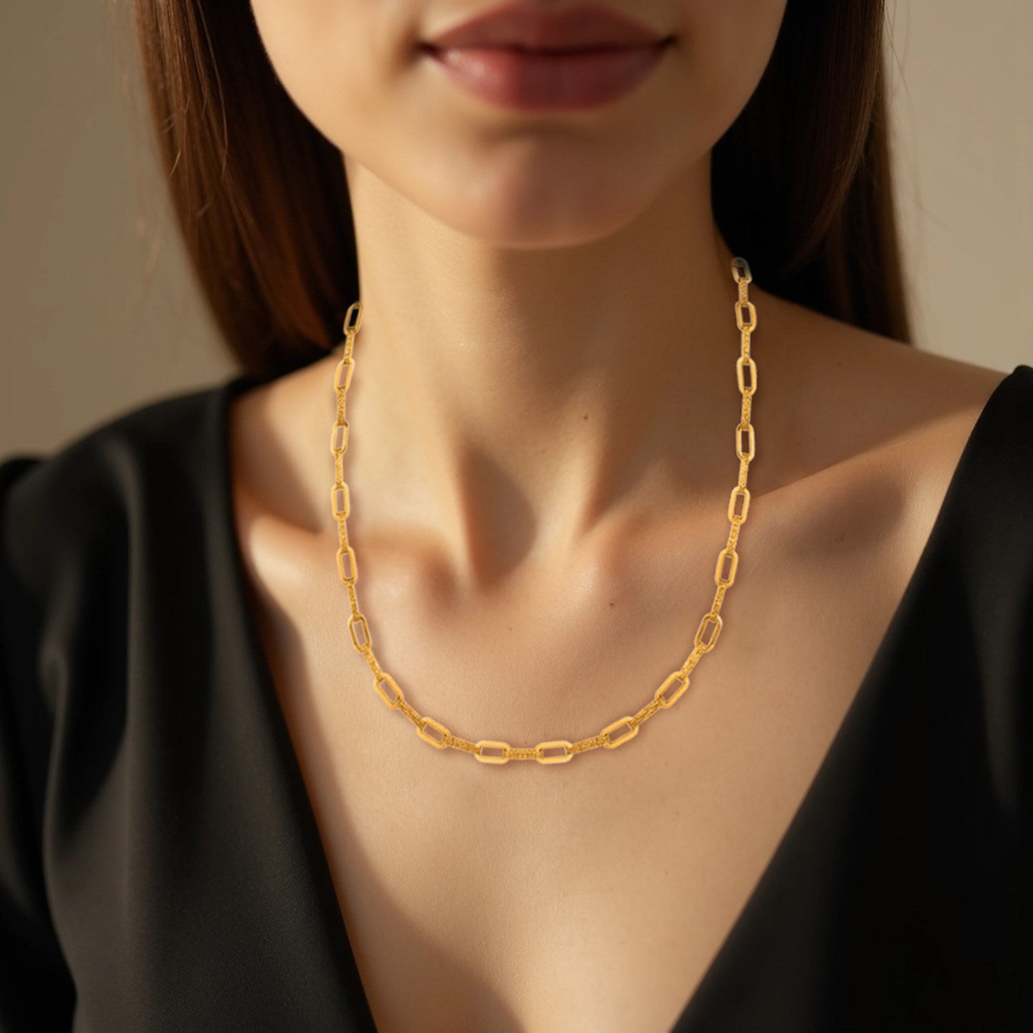 14k yellow gold paperclip chain necklace on a woman's neck.