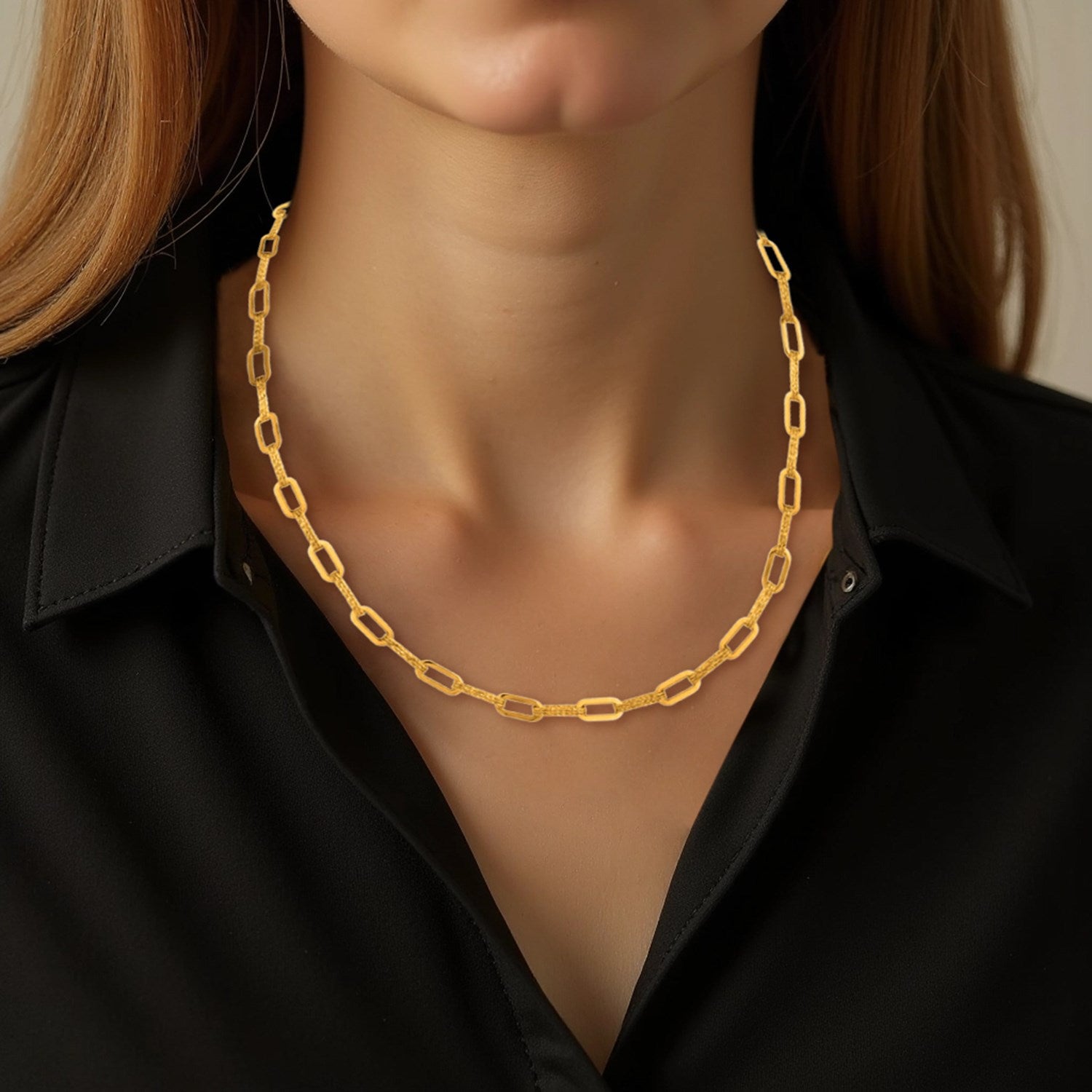 14k yellow gold diamante paperclip chain necklace on a person.
