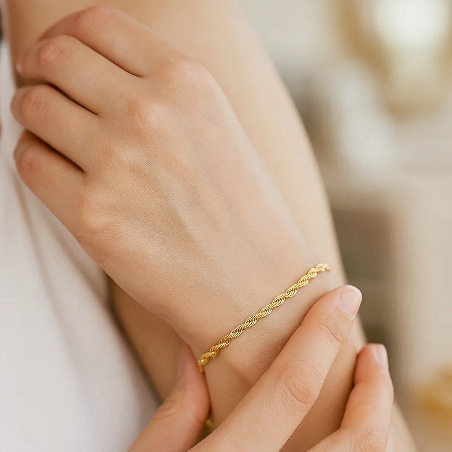 10k yellow gold solid diamond cut rope bracelet on a person's wrist.