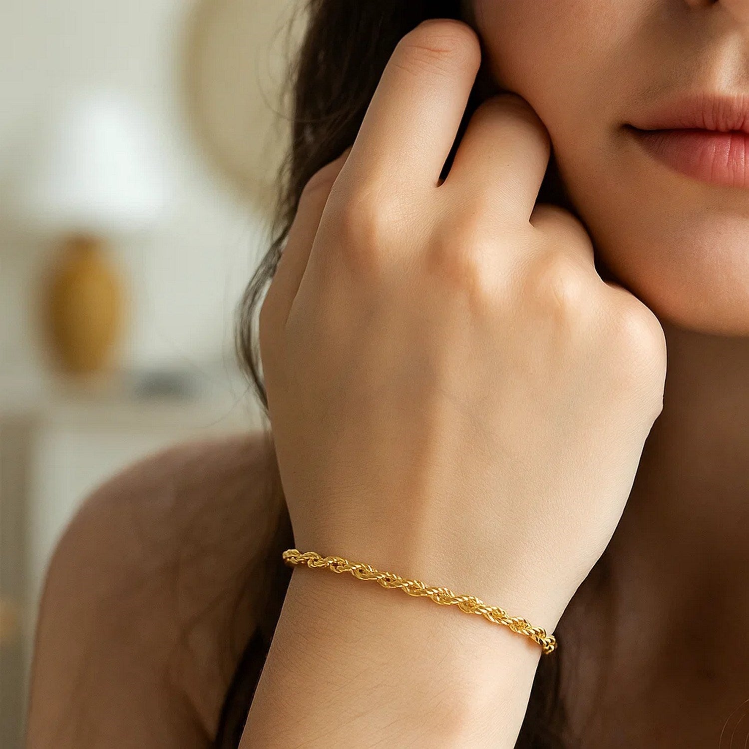 10k yellow gold solid diamond cut rope bracelet on a woman's wrist.