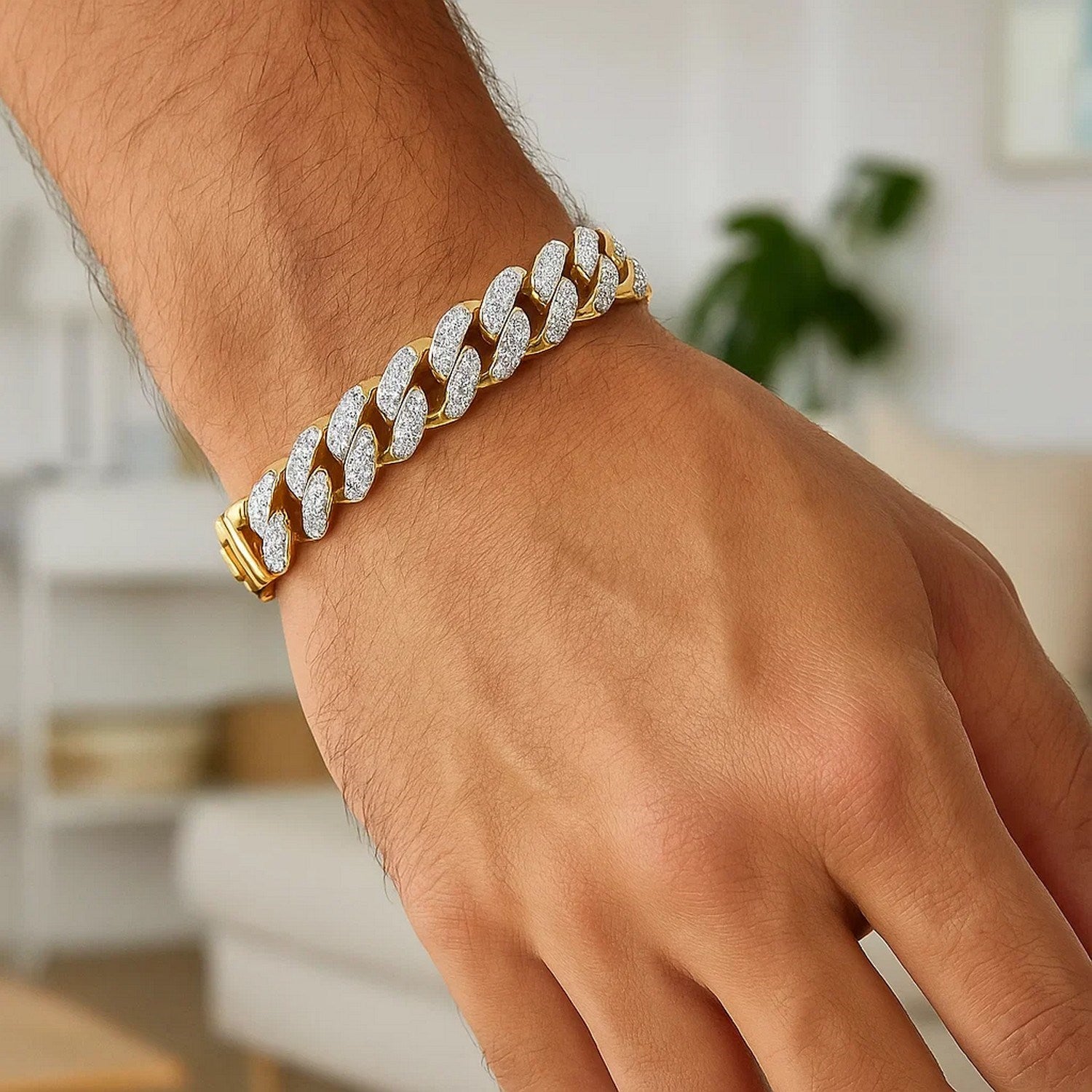 14k two-tone gold curb chain bracelet with diamond pave links on a man's wrist.