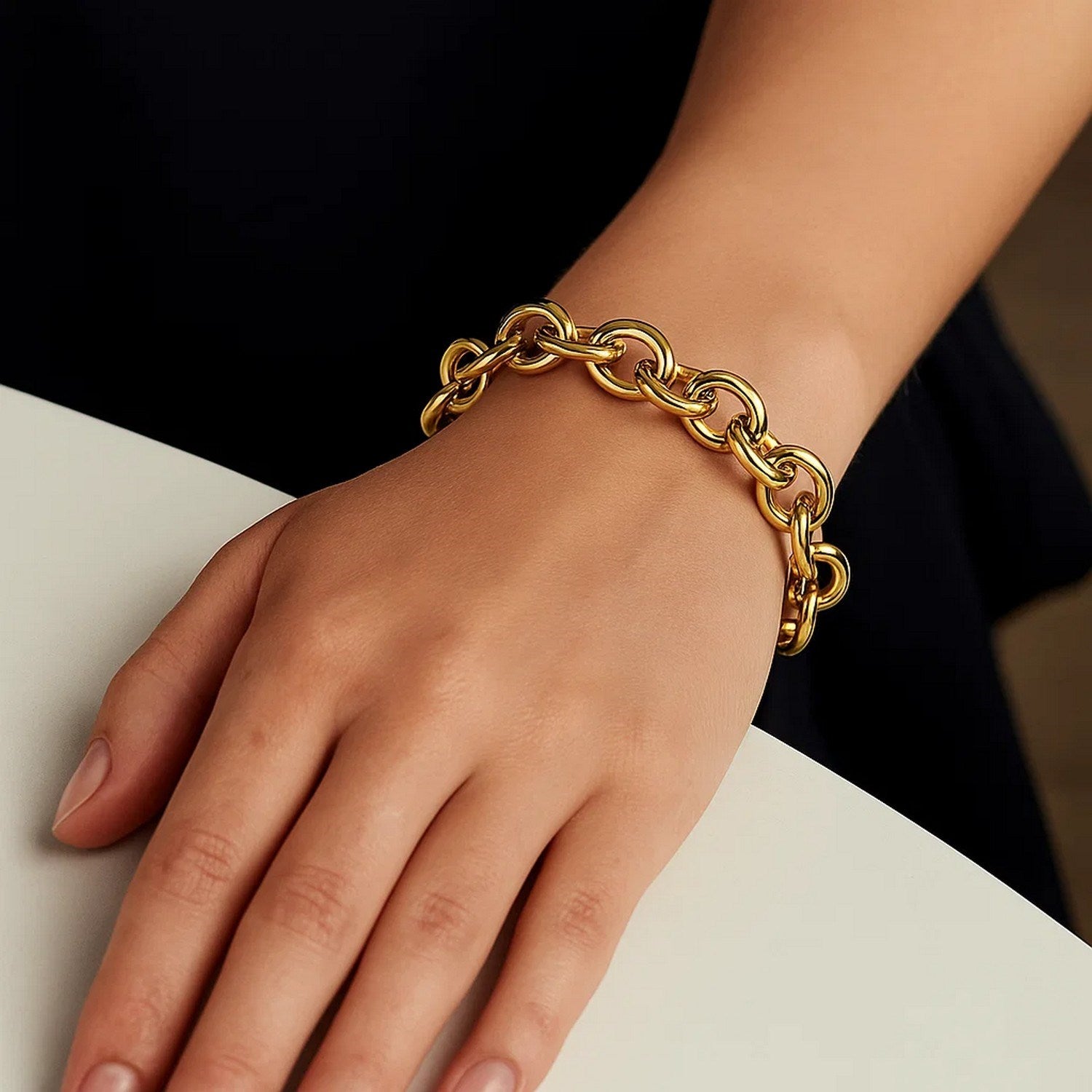 14k yellow gold round link bracelet with a high polish finish on a person's wrist.