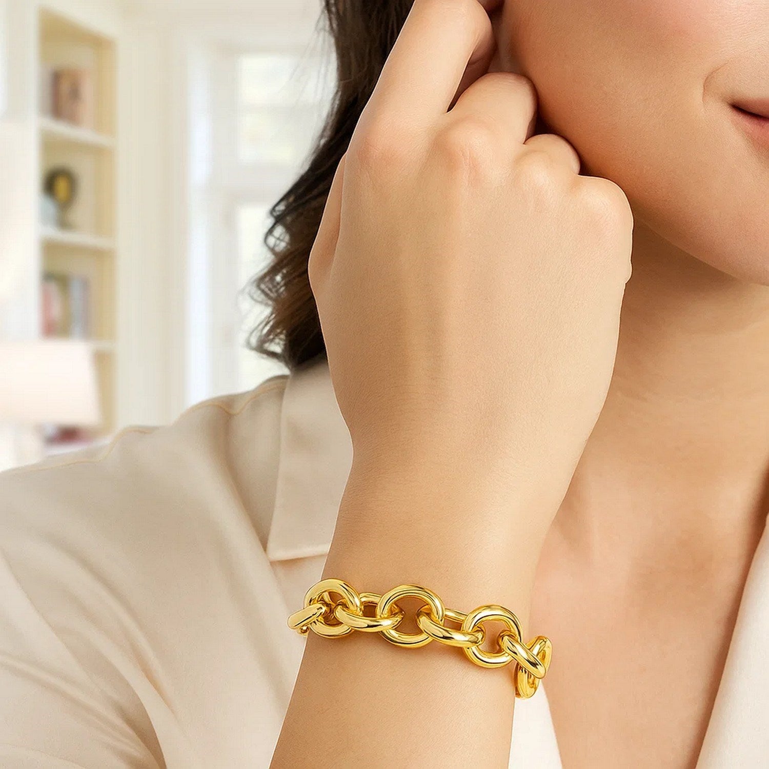 14k yellow gold round link bracelet on a woman's wrist.