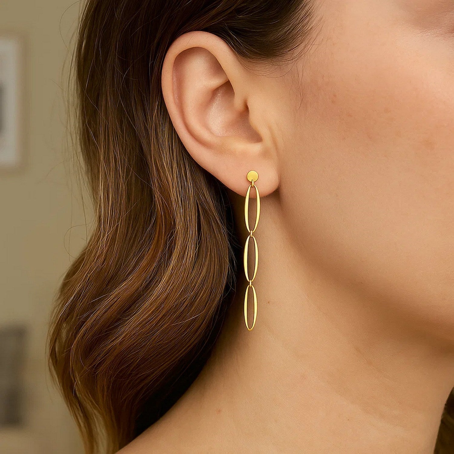 14K yellow gold triple oval fancy drop earrings with a push-back closure.