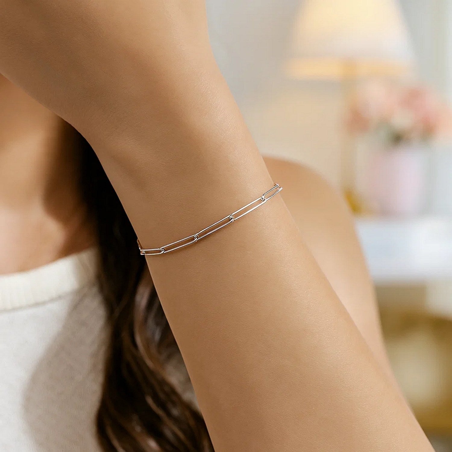 A 14k white gold wire paperclip bracelet with 2.70 mm links on a woman's arm.
