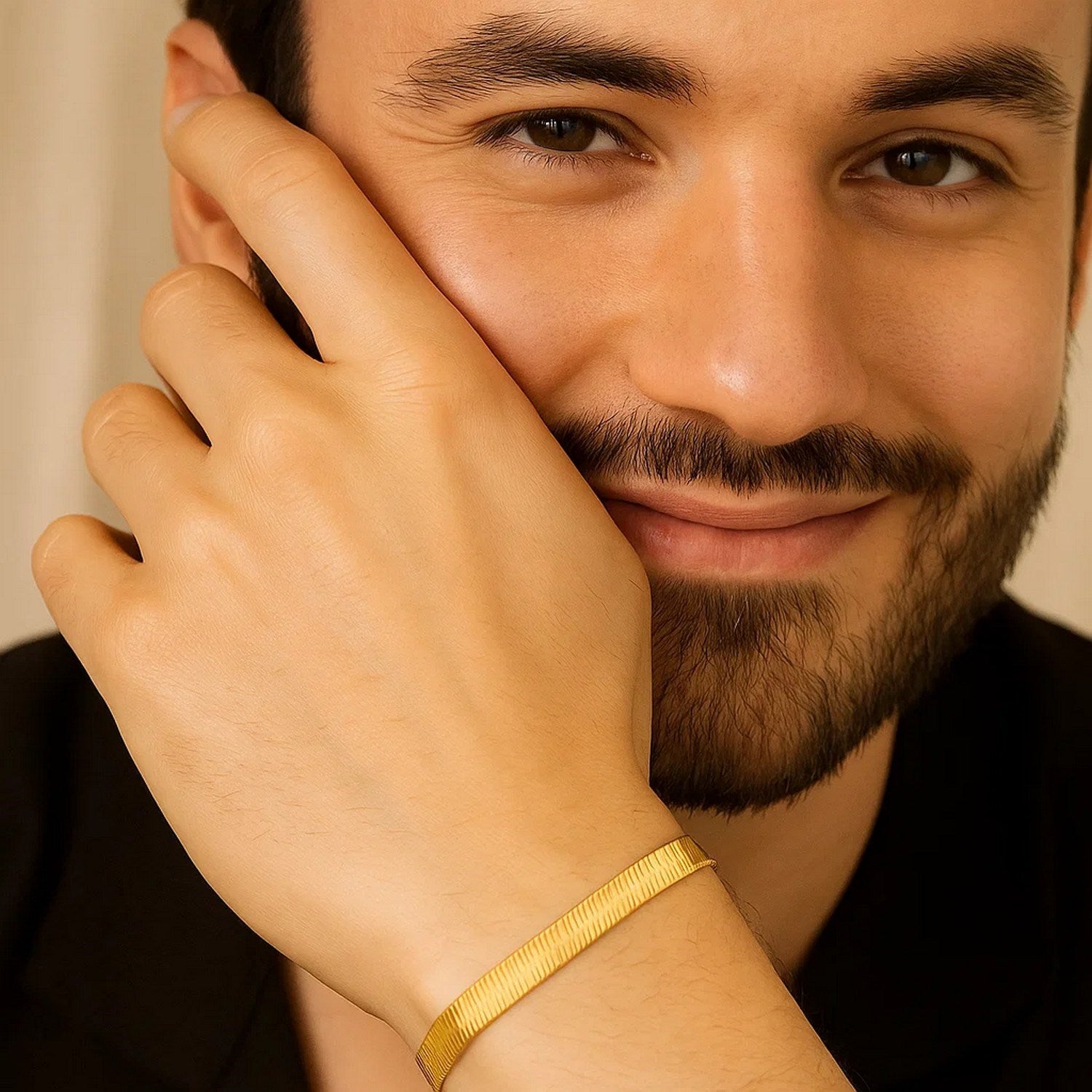 14k yellow gold super flex herringbone bracelet on a man's wrist.