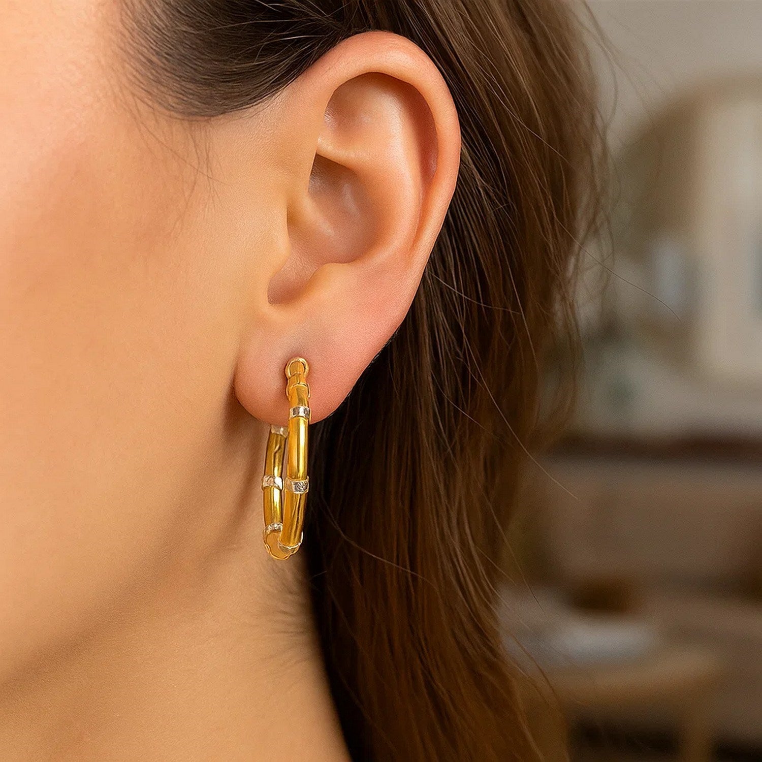 14k two-tone gold alternate textured hoop earrings with white tone sections.