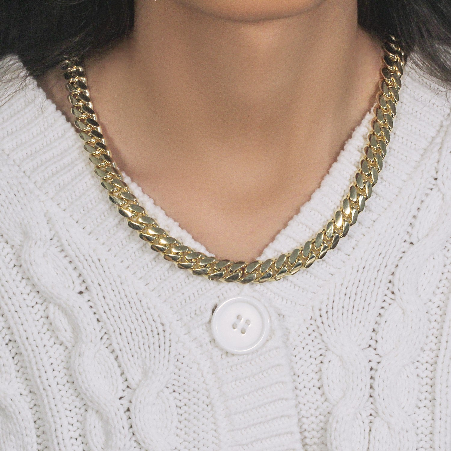 14k yellow gold classic Miami Cuban solid chain, 10.10 mm wide, worn on a person.